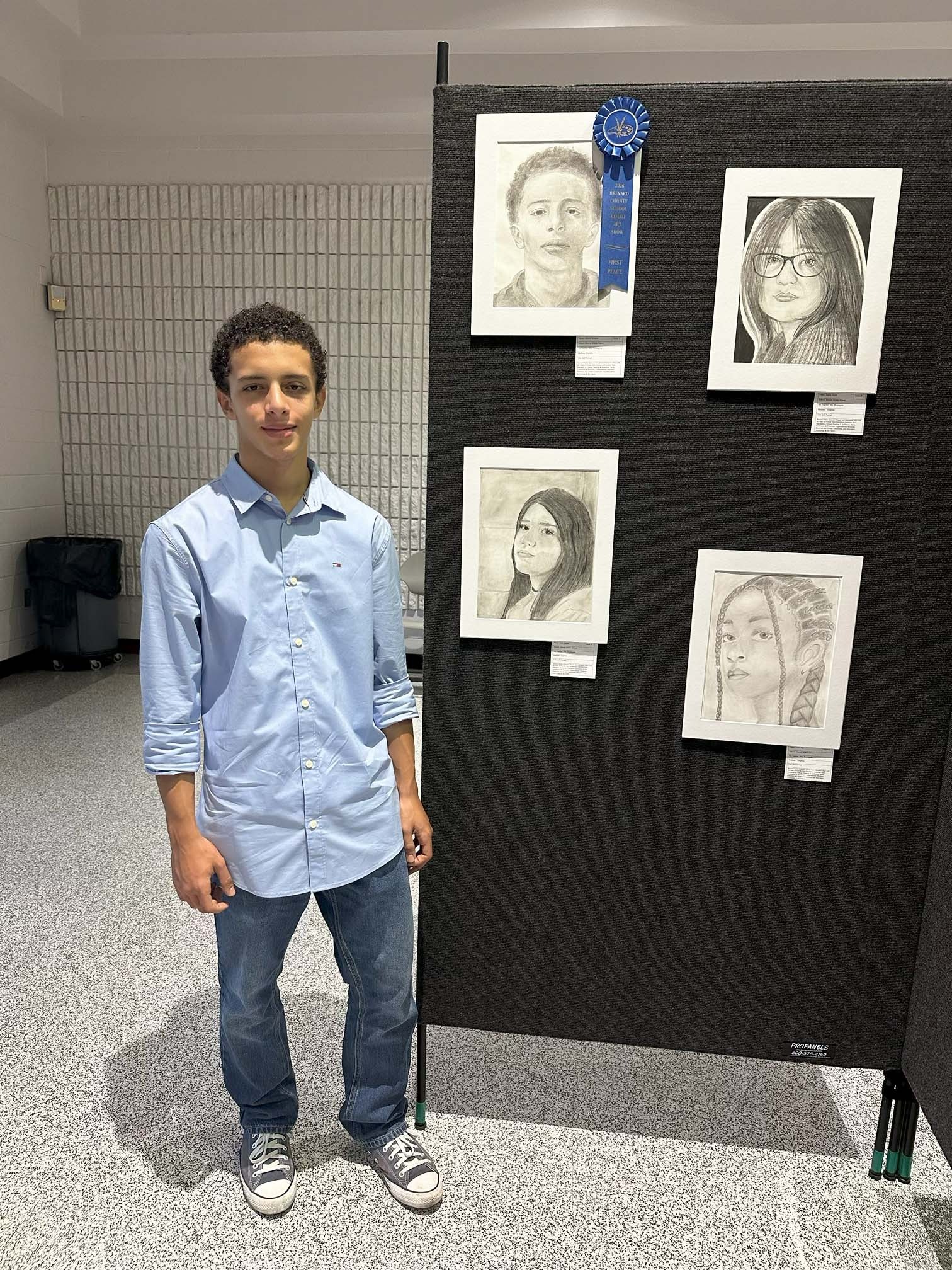 Art student stands with first place winning self portrait