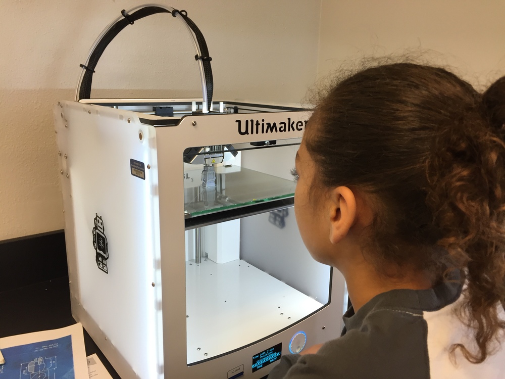 Girl using a 3D Printer