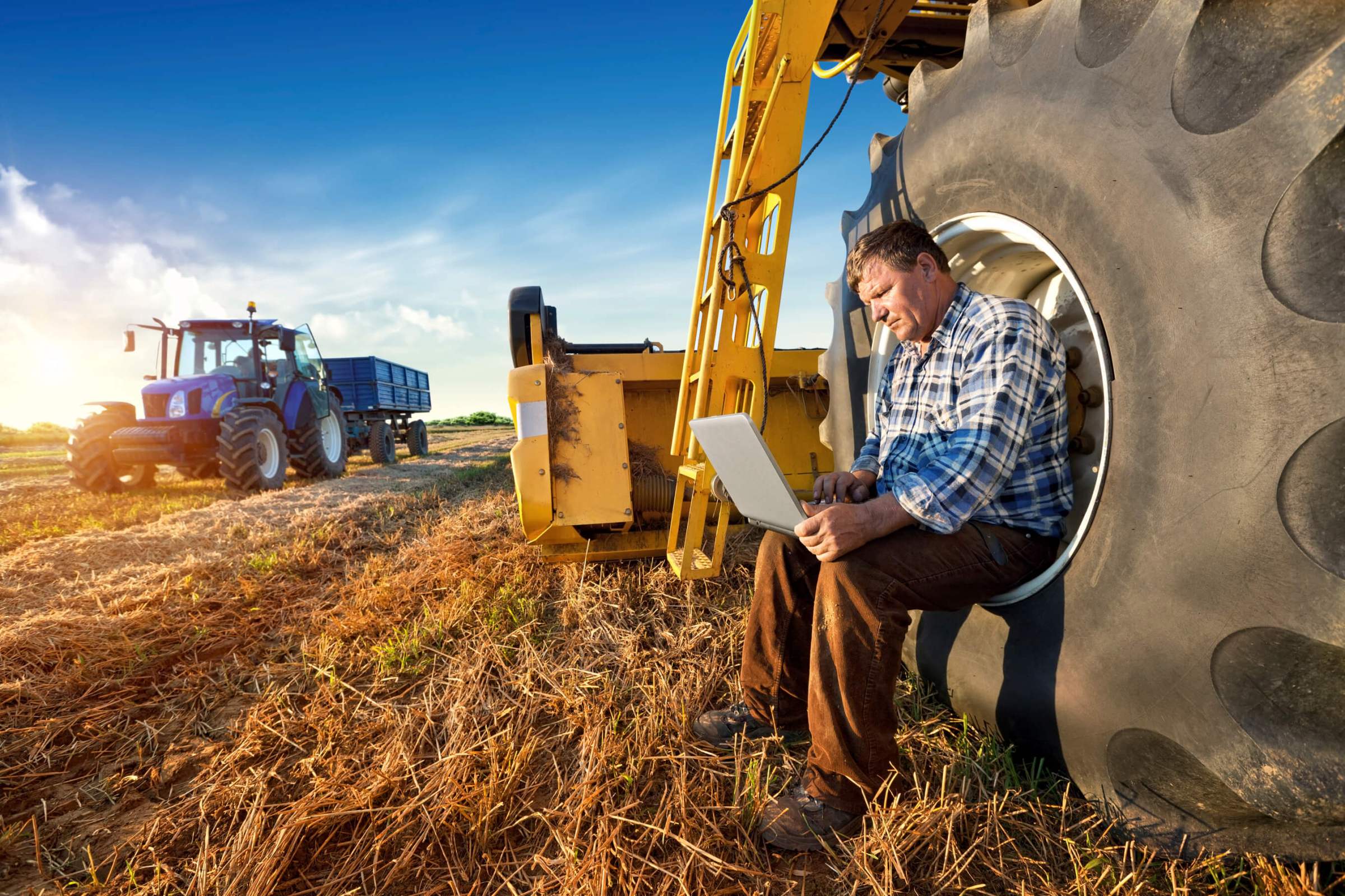 man in sitting in a tractor at a field