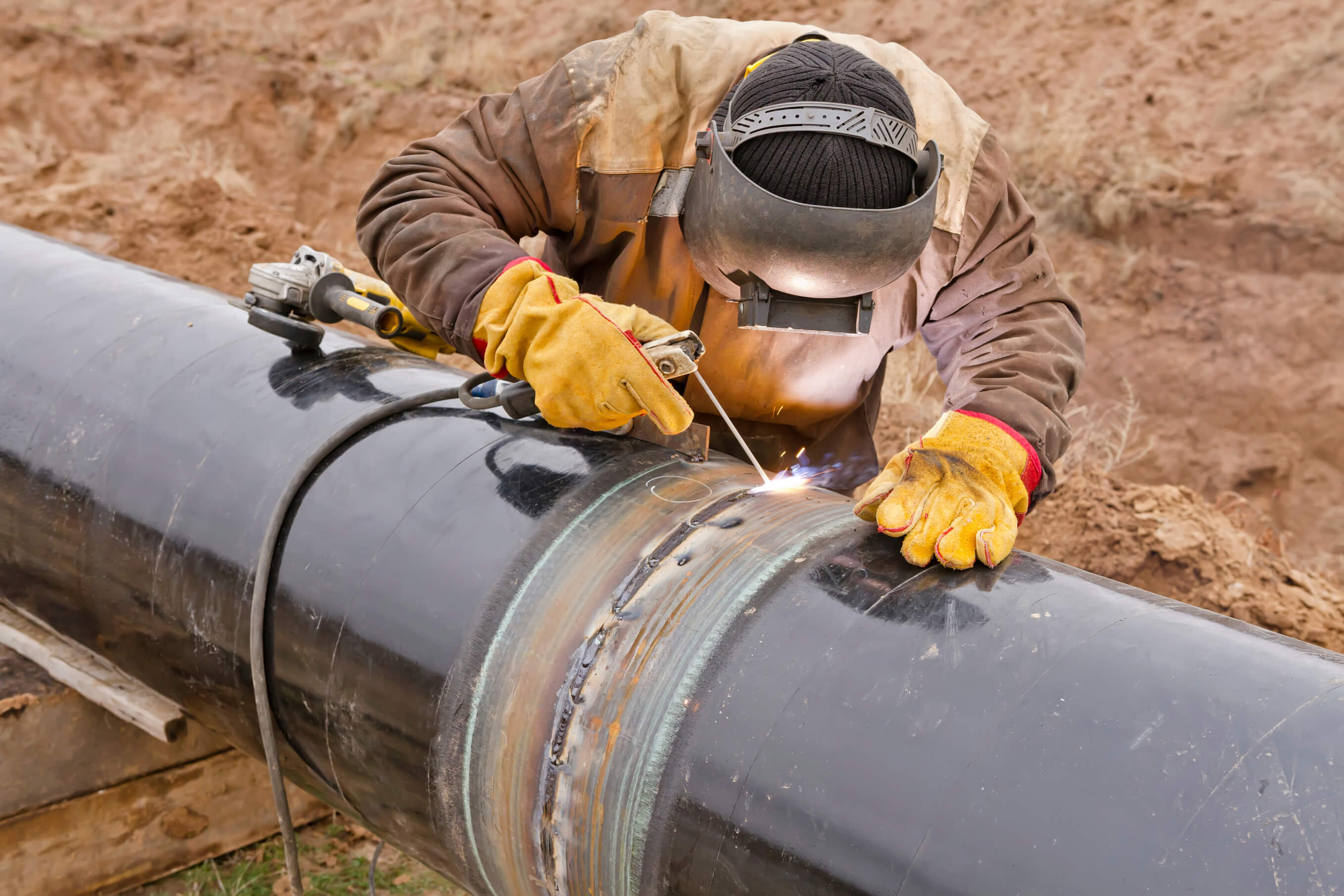 a man welding a pipe 