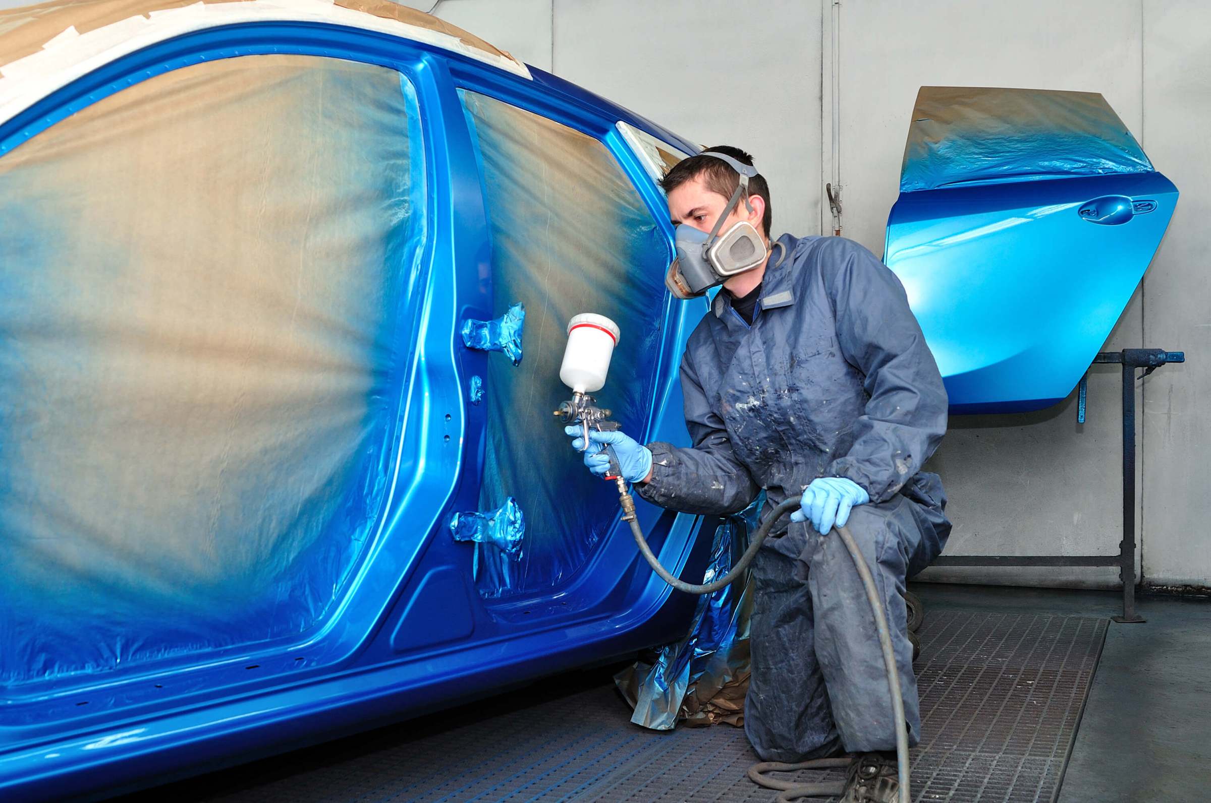 man painting a car 