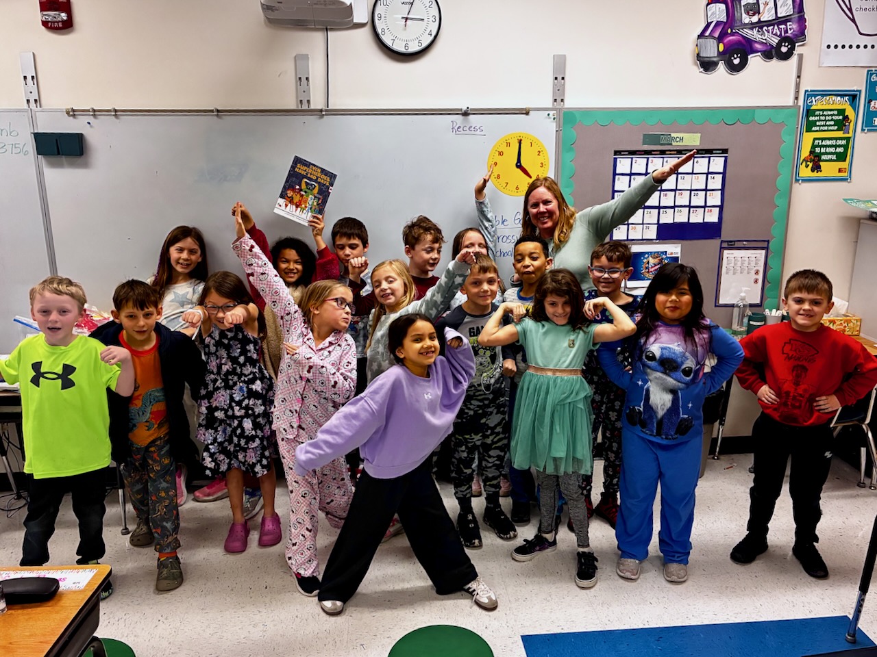 Second Grade Class Posing like Superheroes