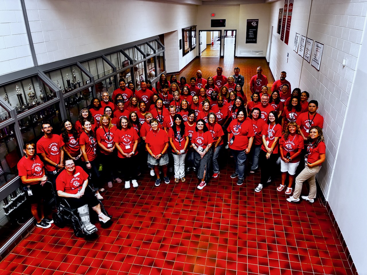 Lansing Middle School Staff smiling in hallway