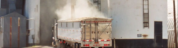 semi truck being filled by grain elevator