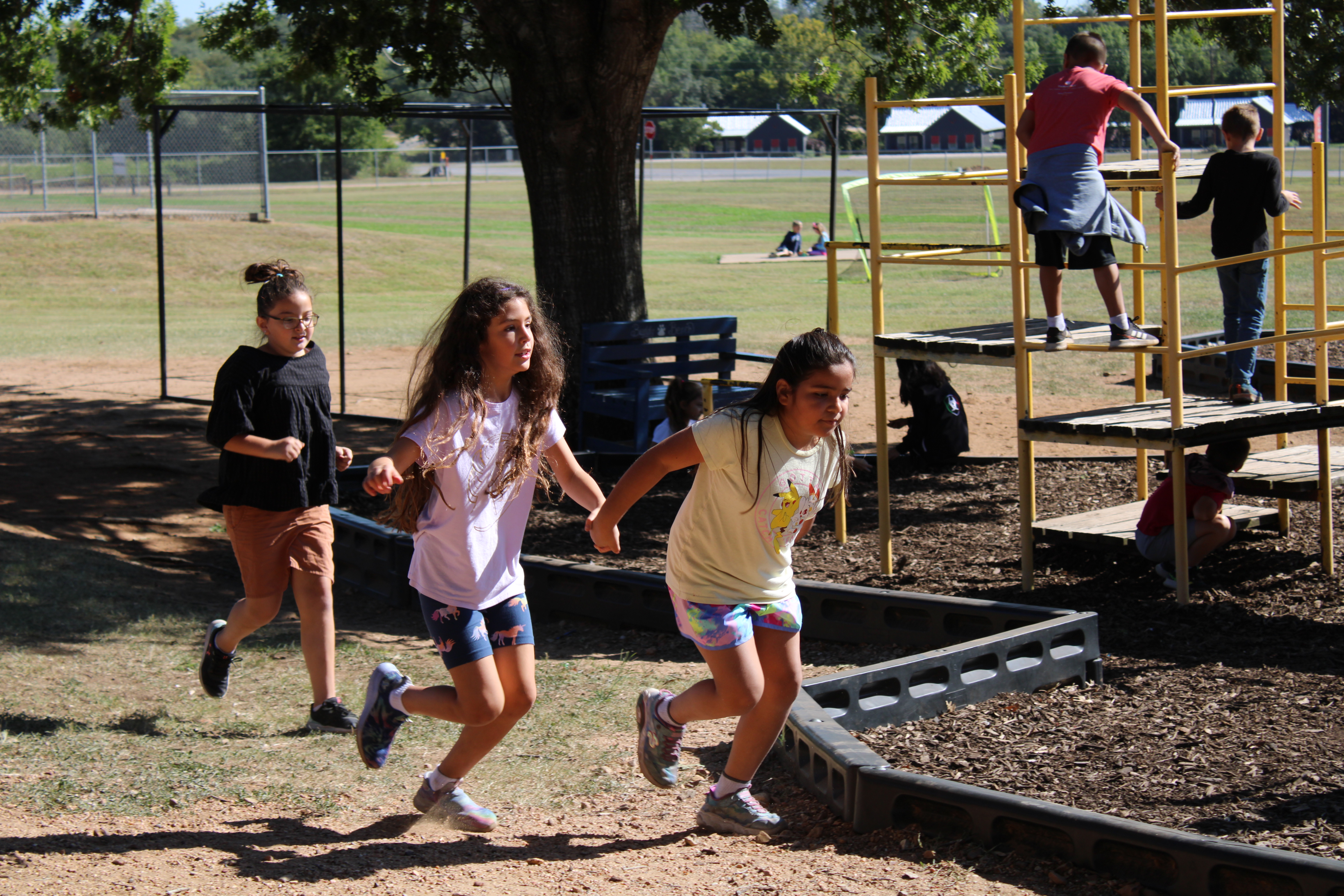 3 girls running on the playground