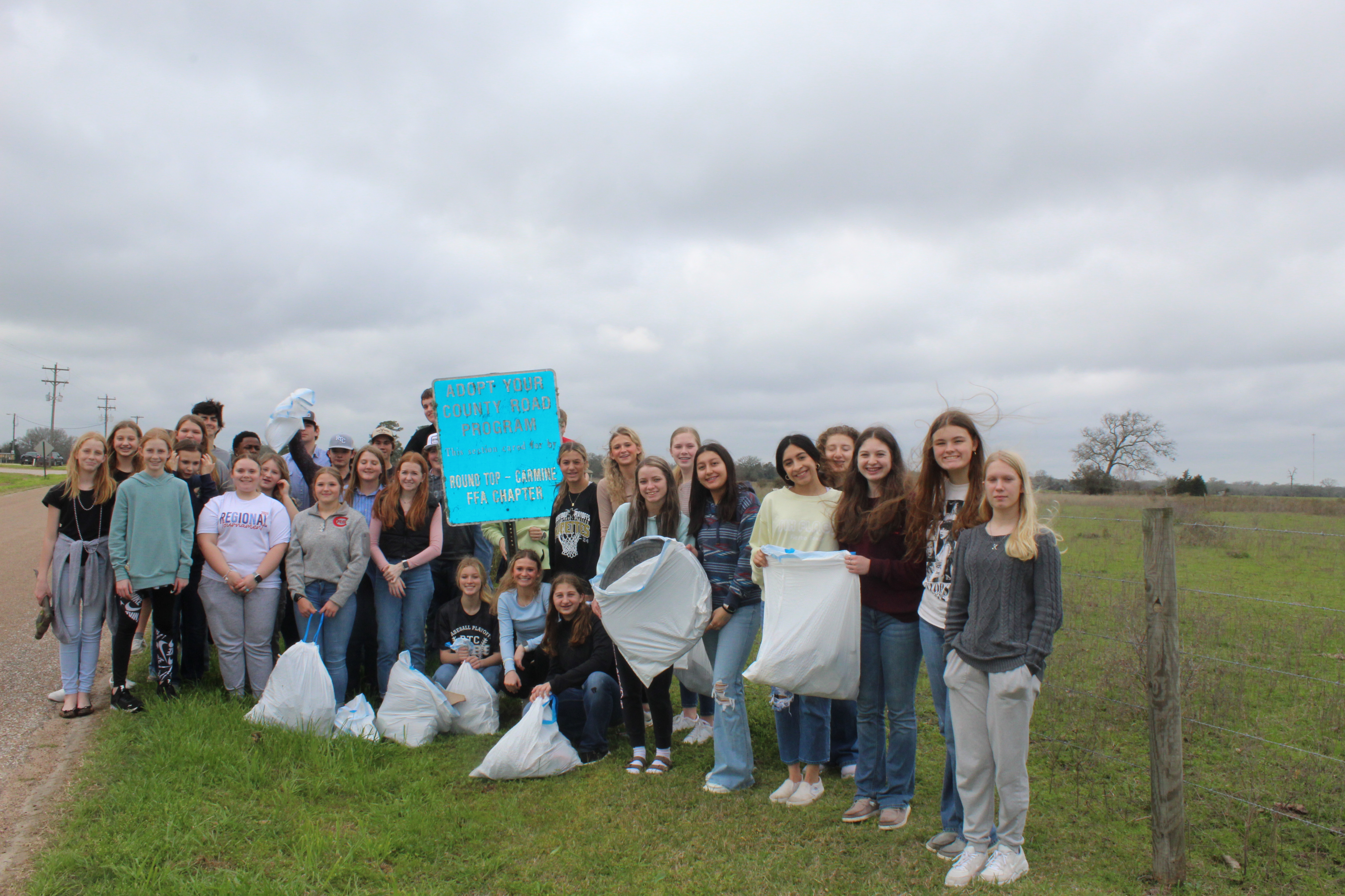 FFA students holding bags of trash