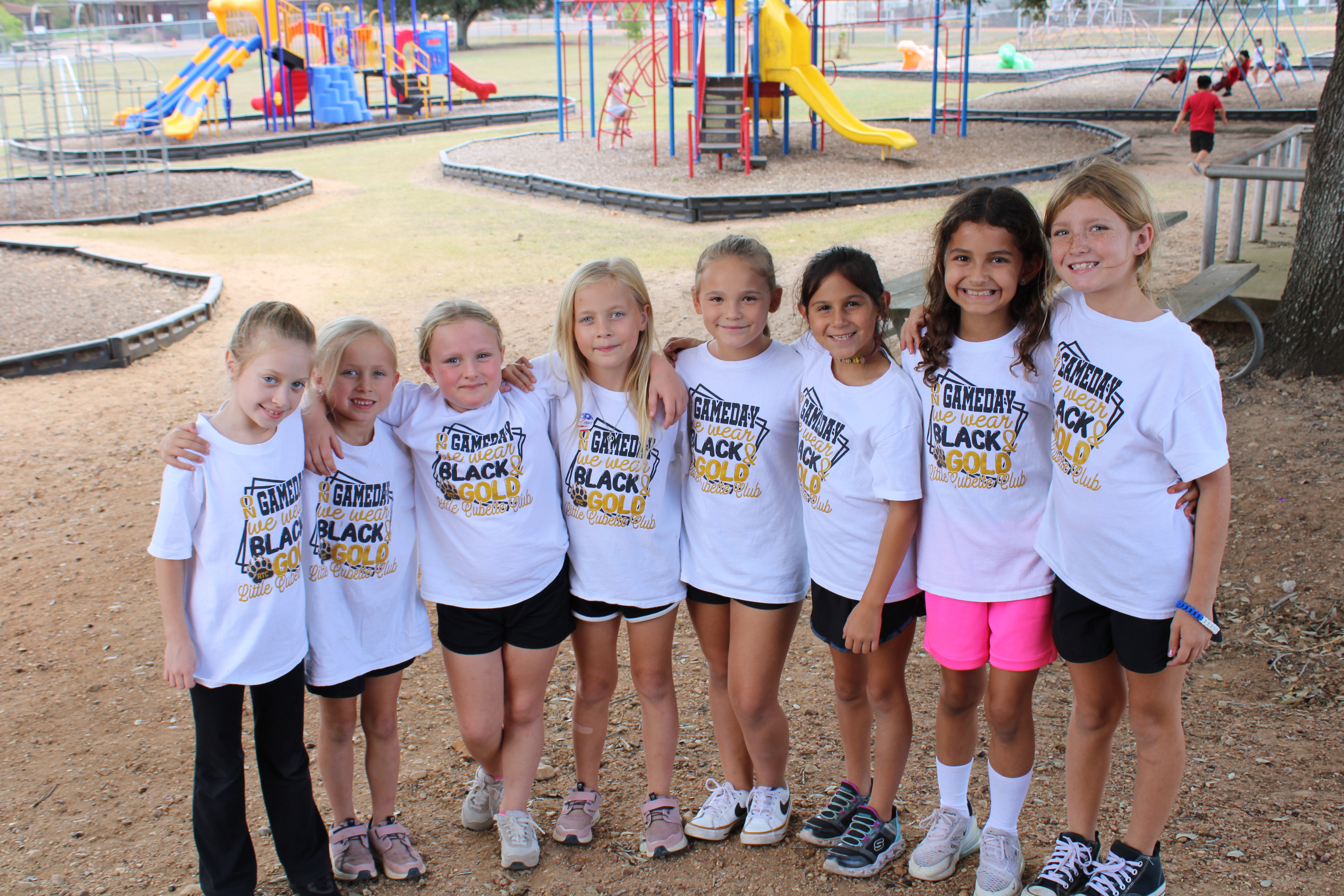 elementary girls dressed in cubette shirs