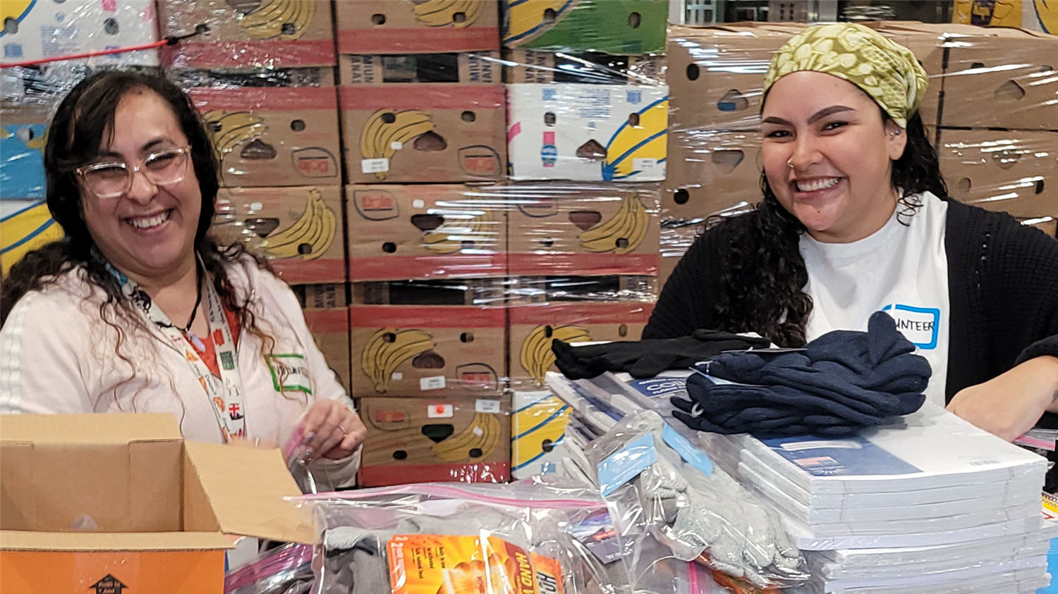 Two individuals sharing a moment at a store, surrounded by boxes and items.