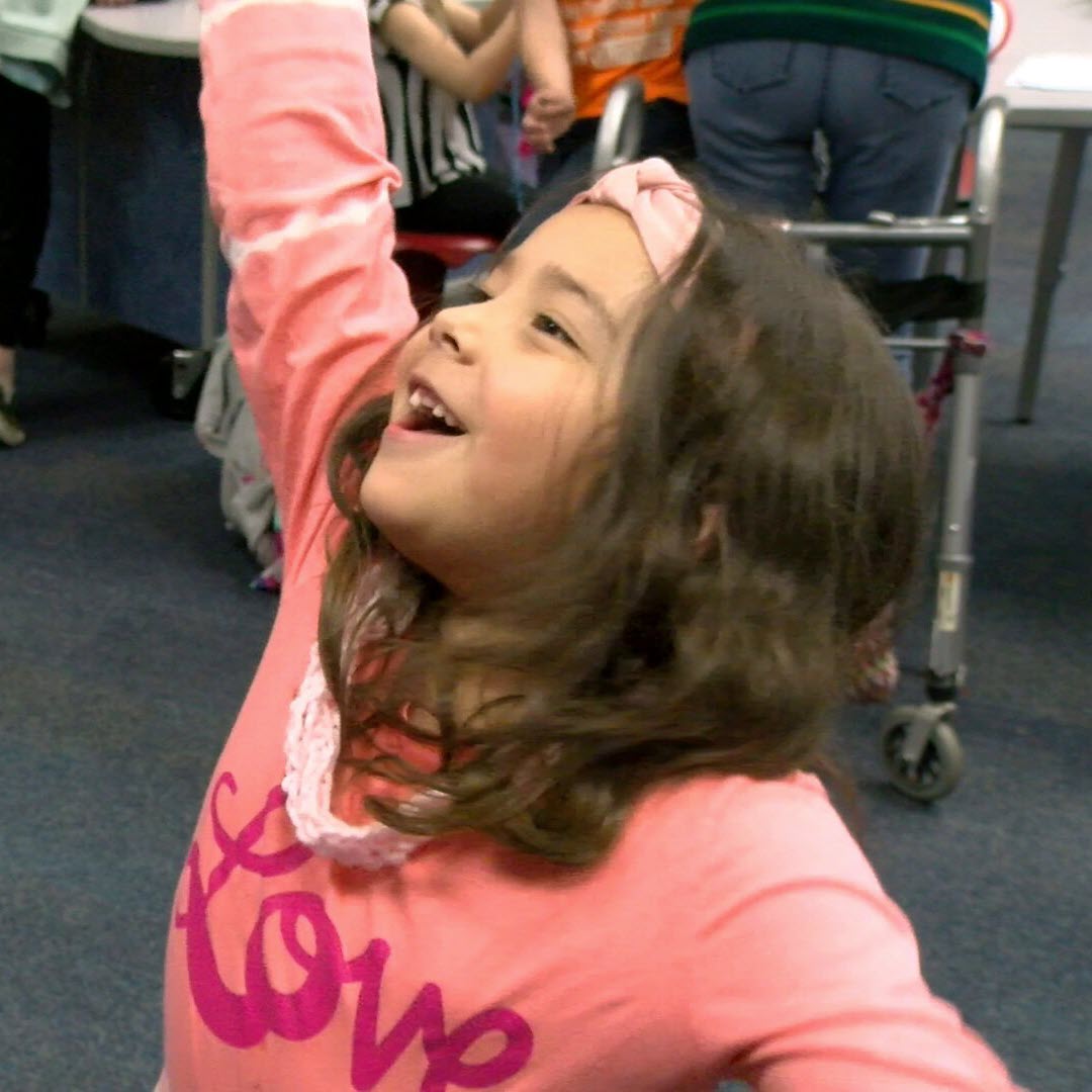 image of student excited about crocheting talking to teacher