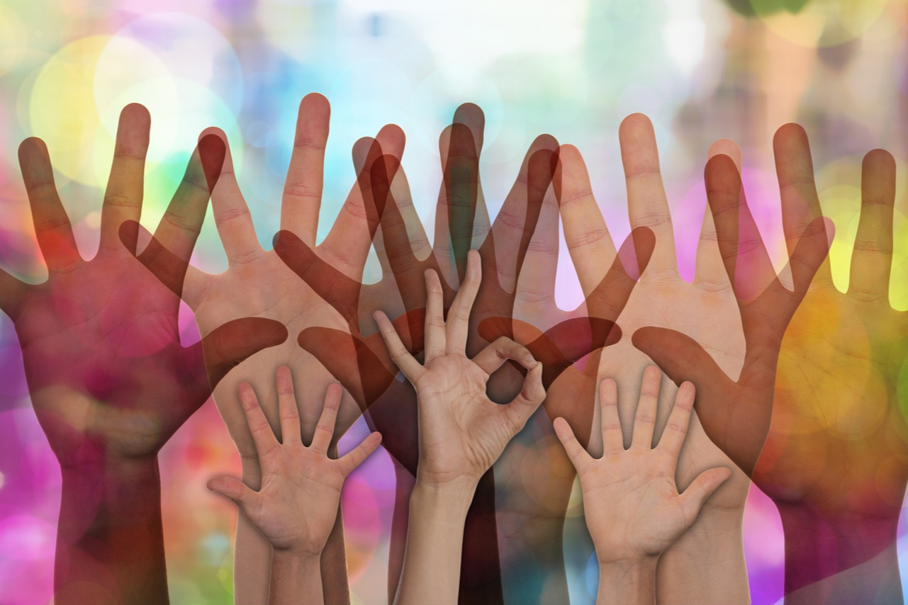 Multi-colored image of raised hands representing volunteers rasing their hands