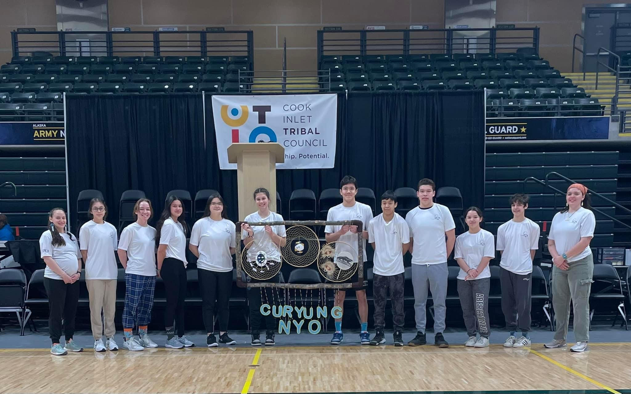 Native Youth Olympics teams with a dillingham school banner