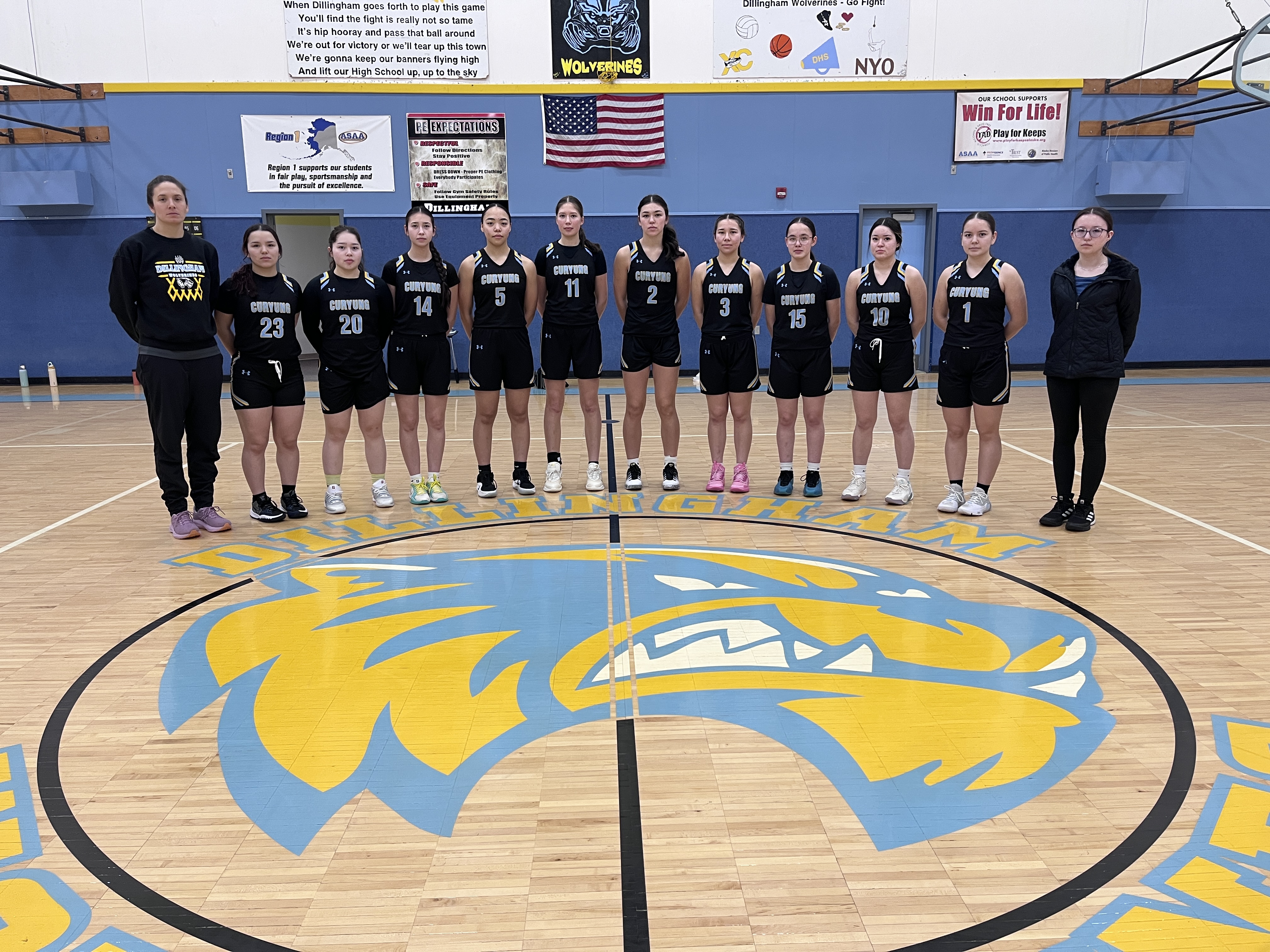 girls basketball team with their coaches
