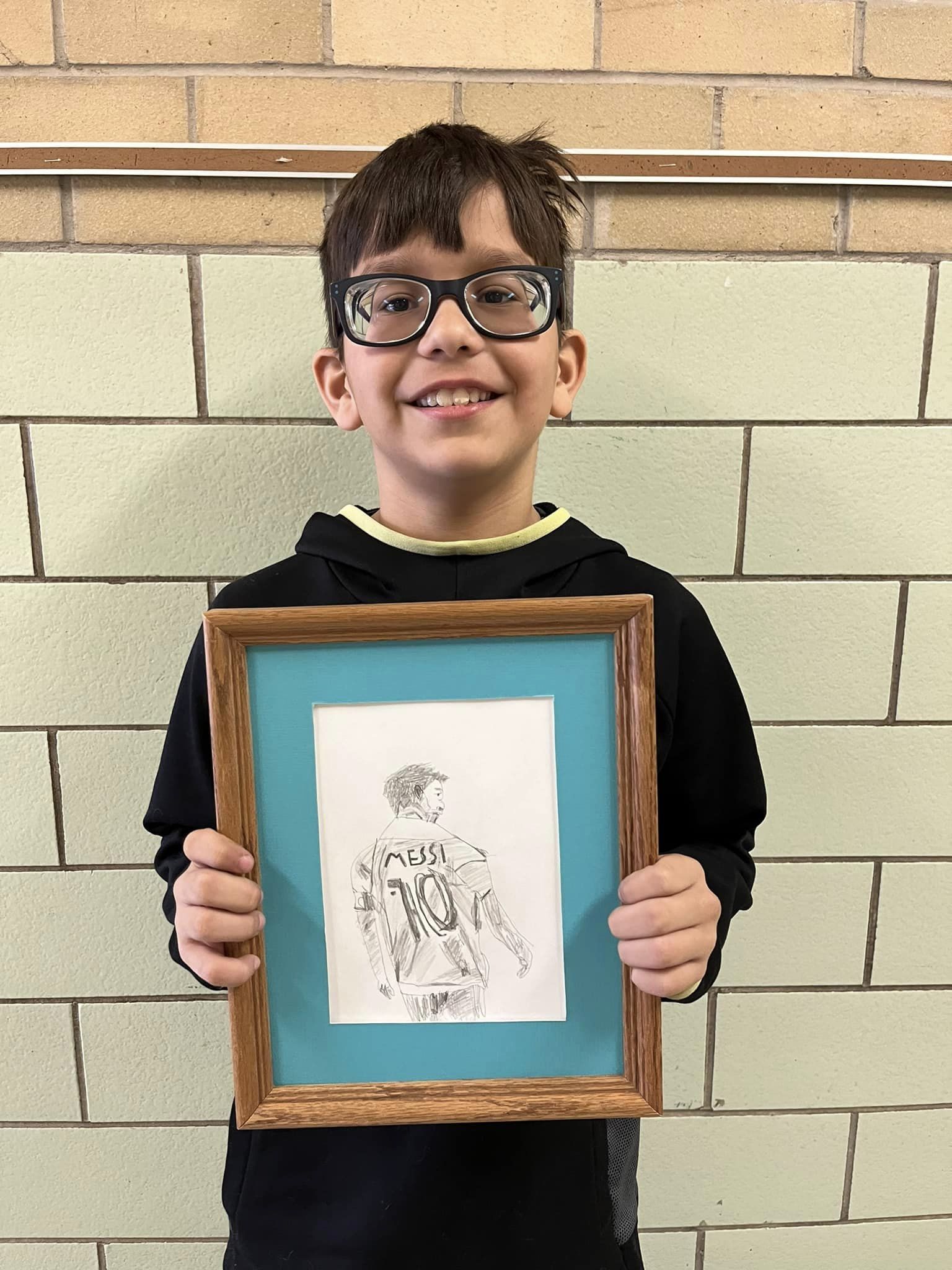 Child holding artwork