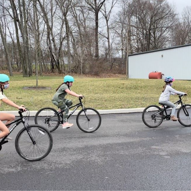 3 girls riding their bikes