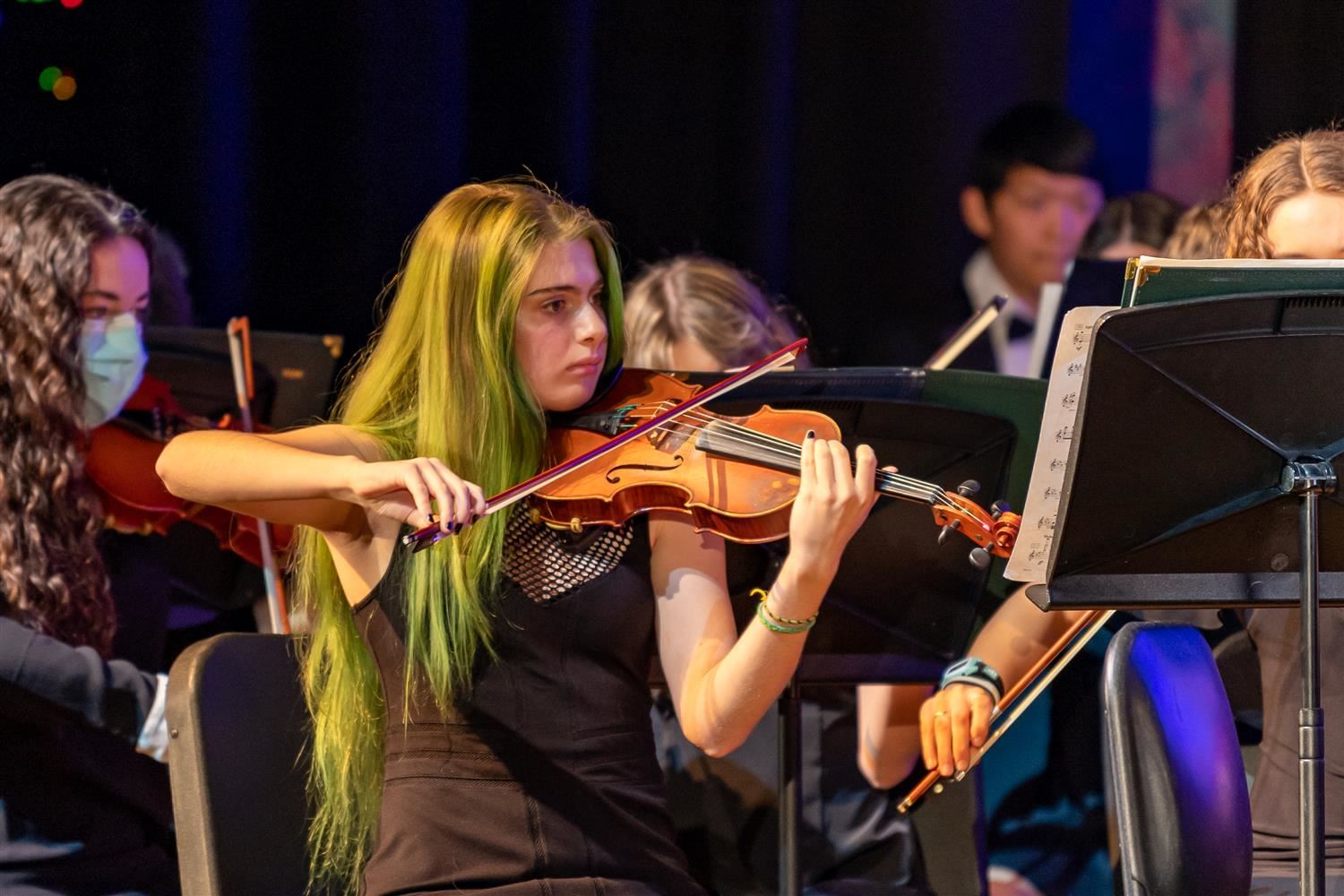 student playing violin on a concert