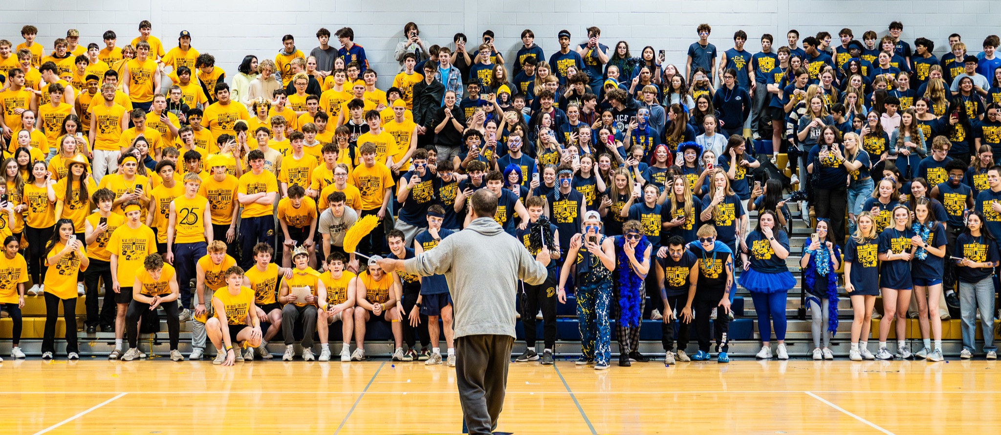 Crowd of students in blue and gold shirts