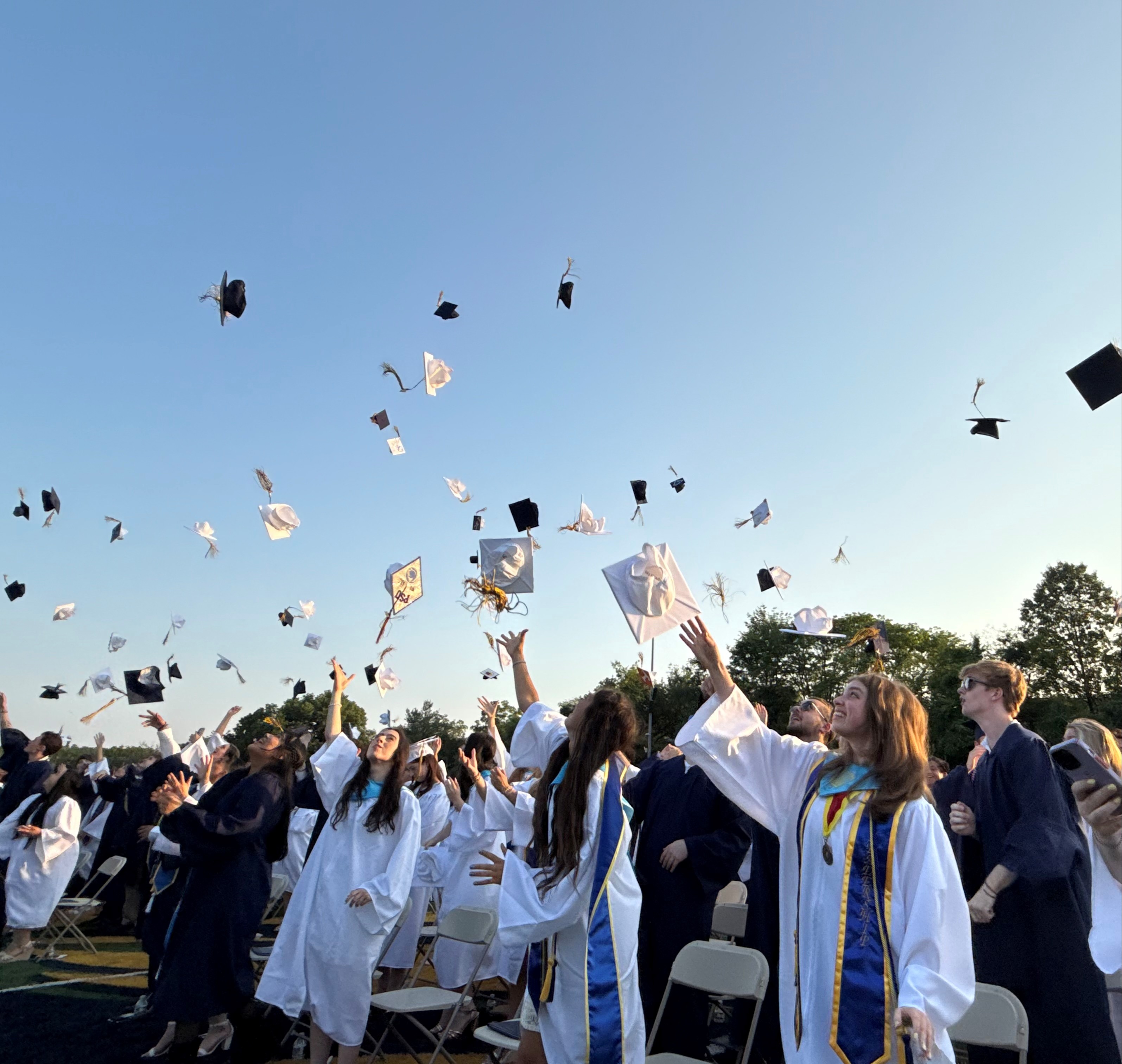 graduates throwing caps