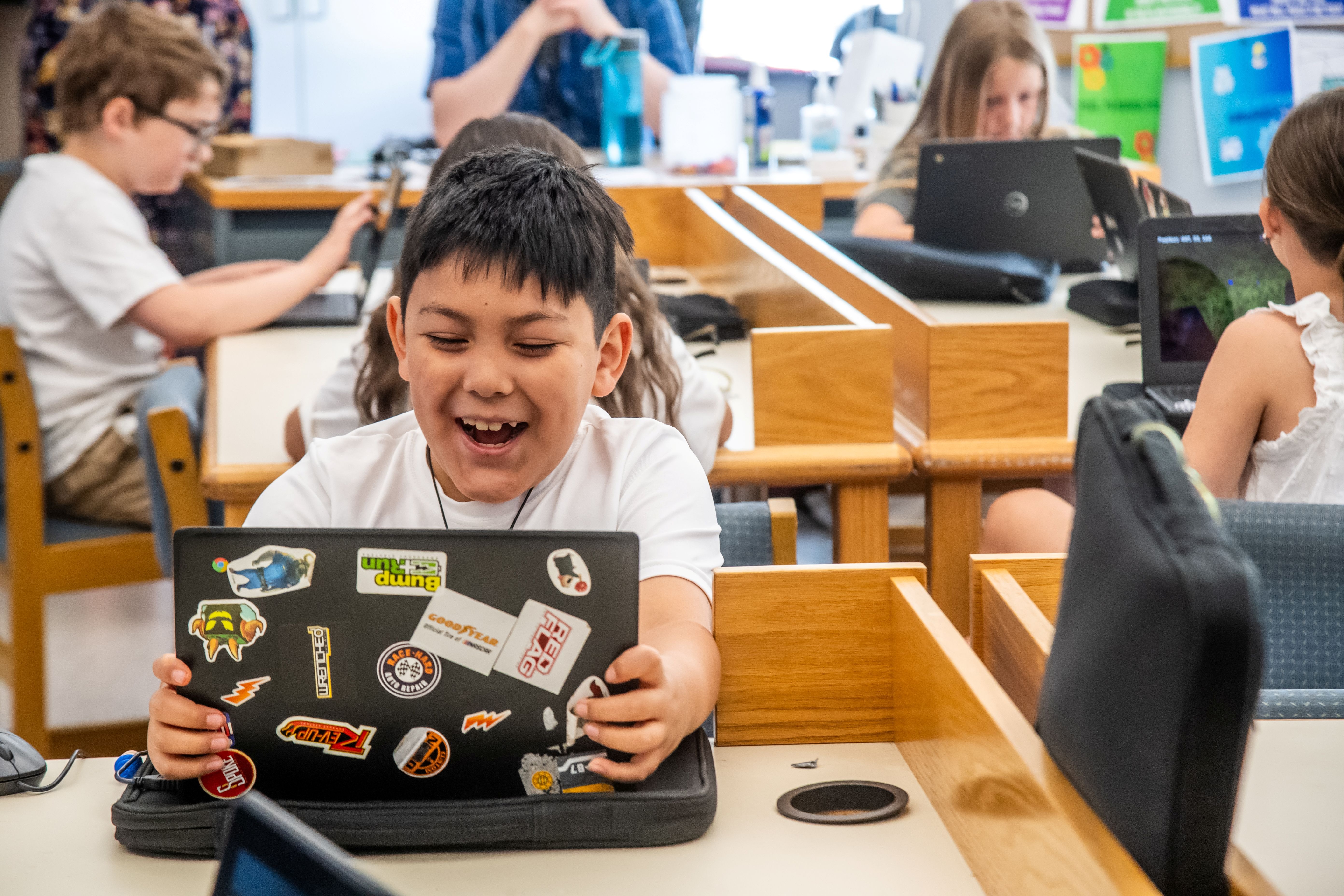 Student learning on computer and laughing