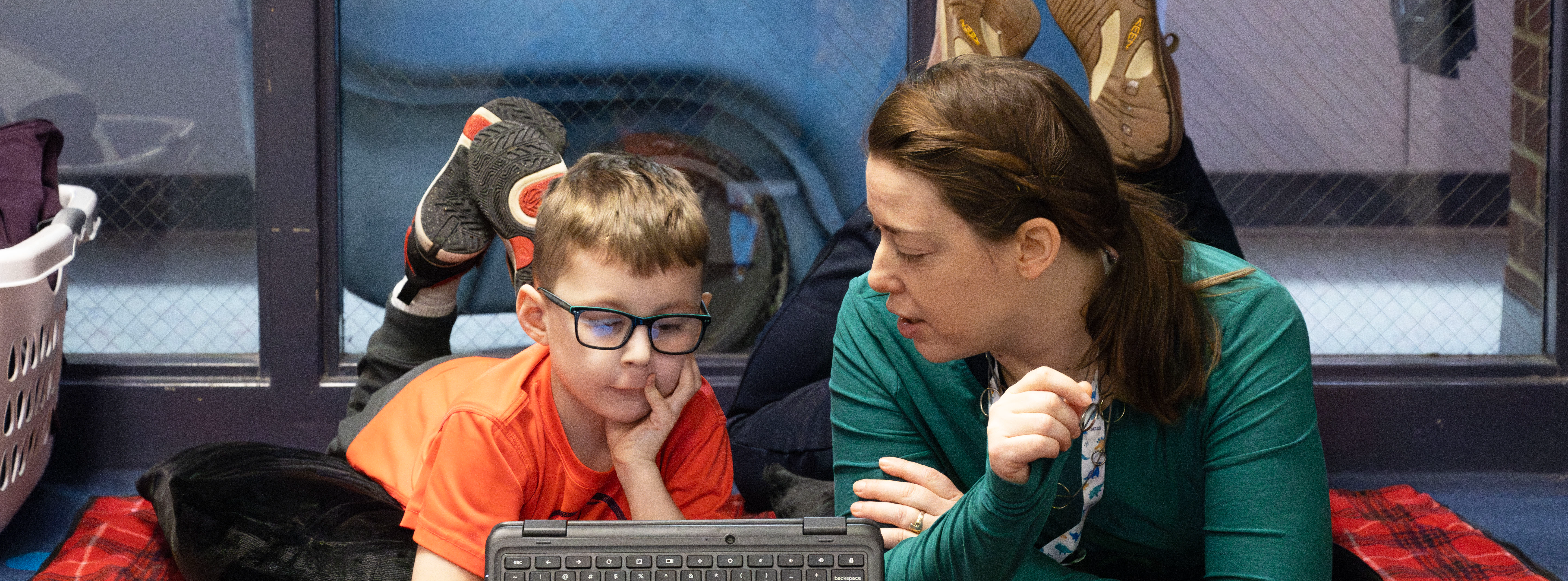 a teacher working with a student