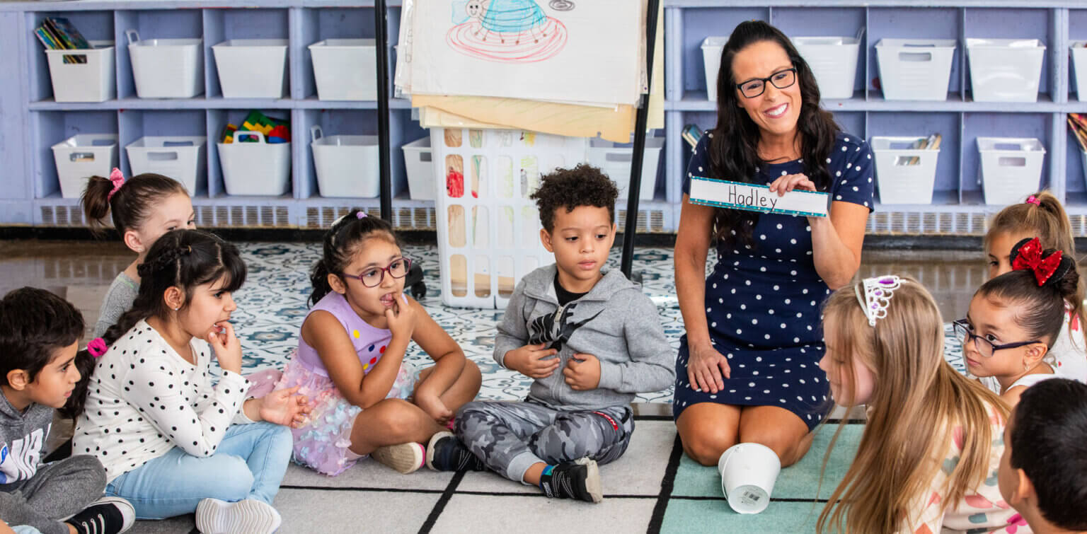 Teacher sitting down with students