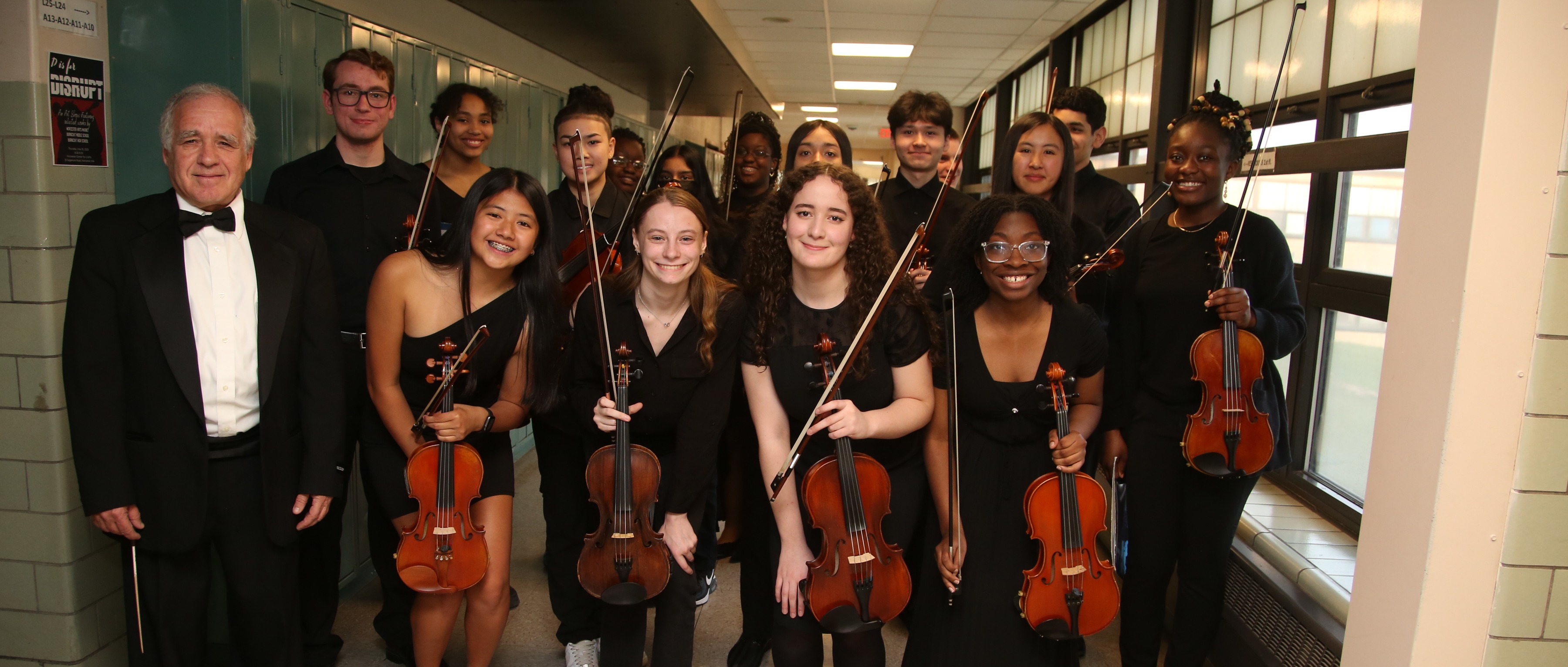 Orchestra students holding violins