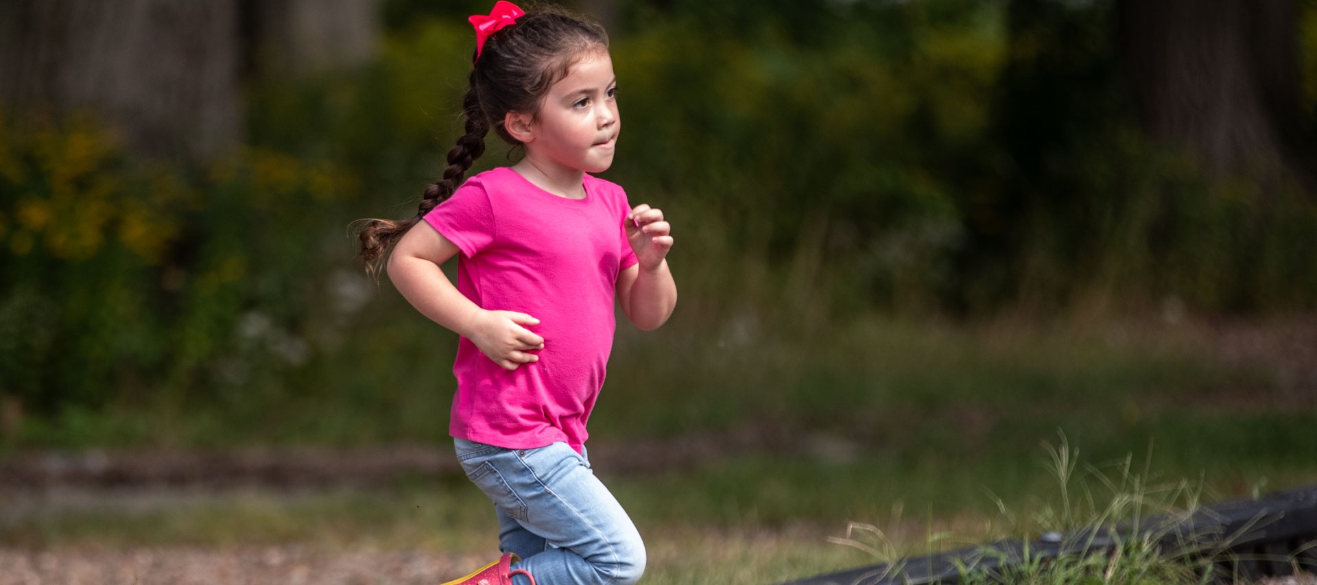 A girl runs outside at recess