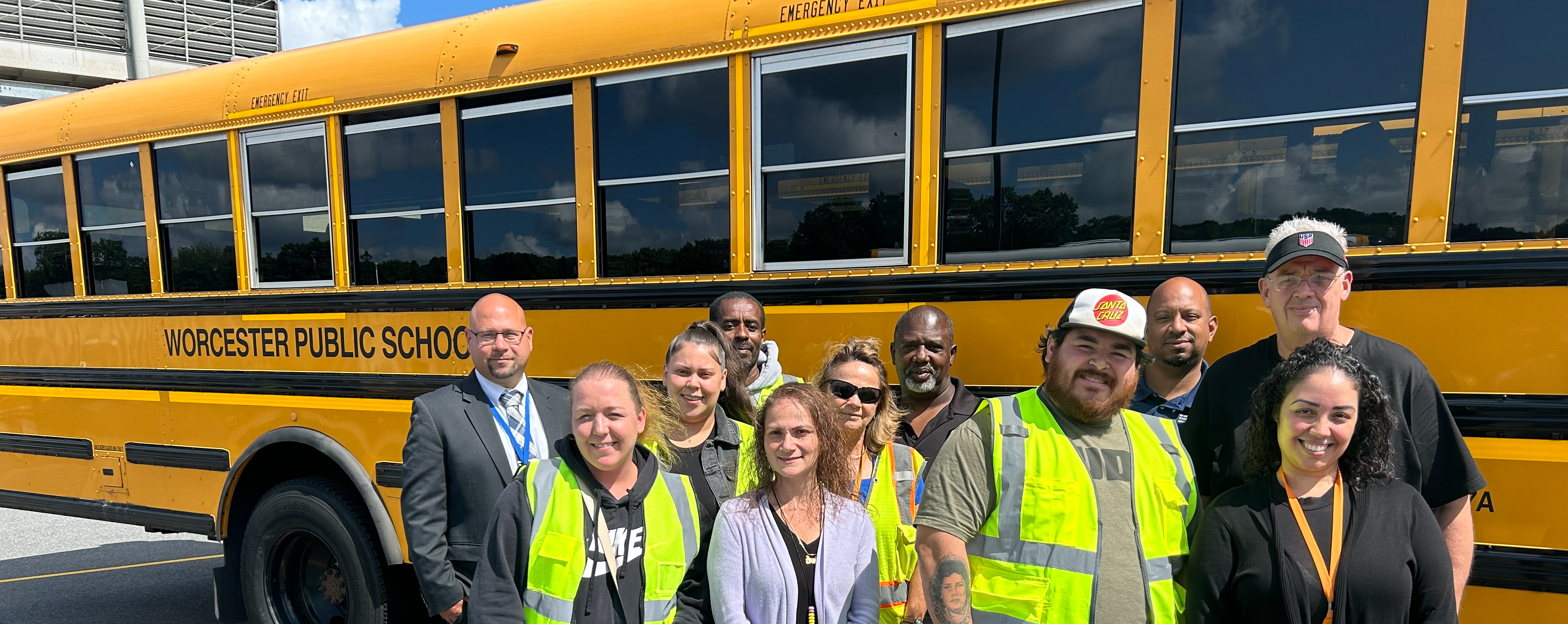 Workers standing in front of a school bus