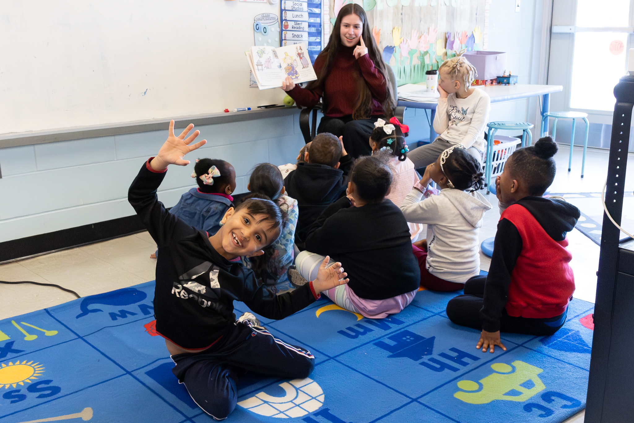 A child in a classroom makes a funny face