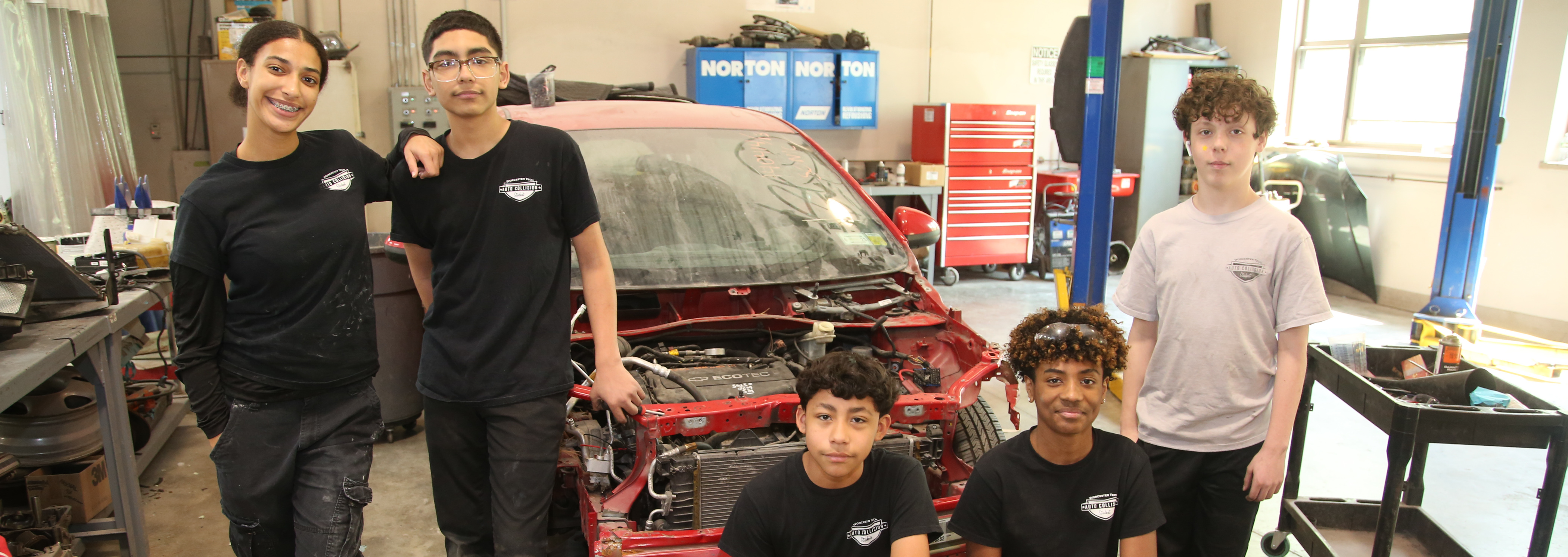 students in an automotive repair garage