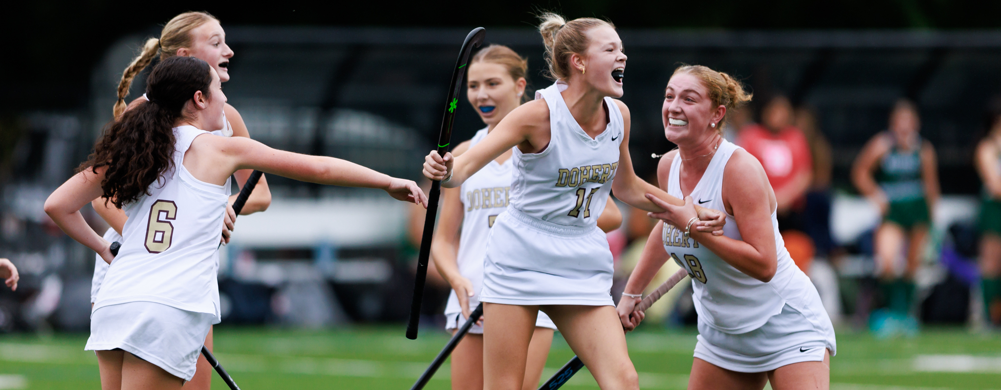 Doherty field hockey celebrates a goal.