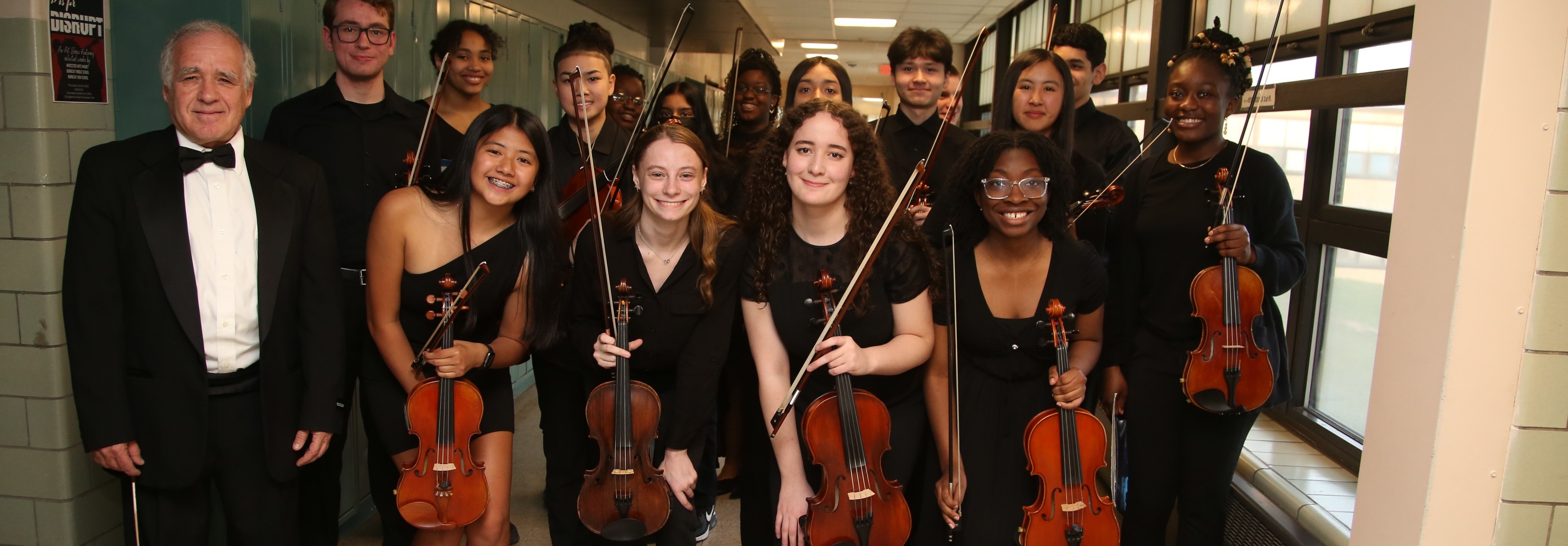 Orchestra students holding violins