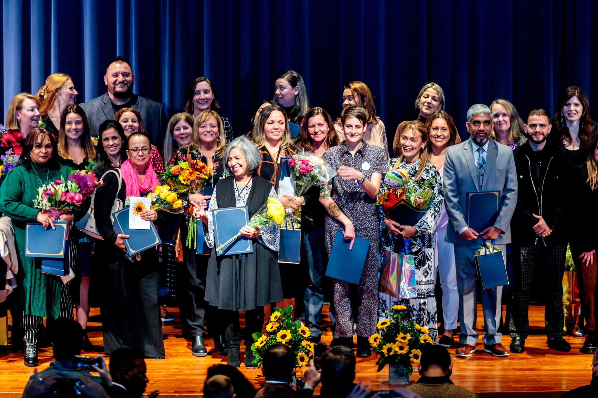 A large group of WPS educators on stage at the Evening of Innovation.