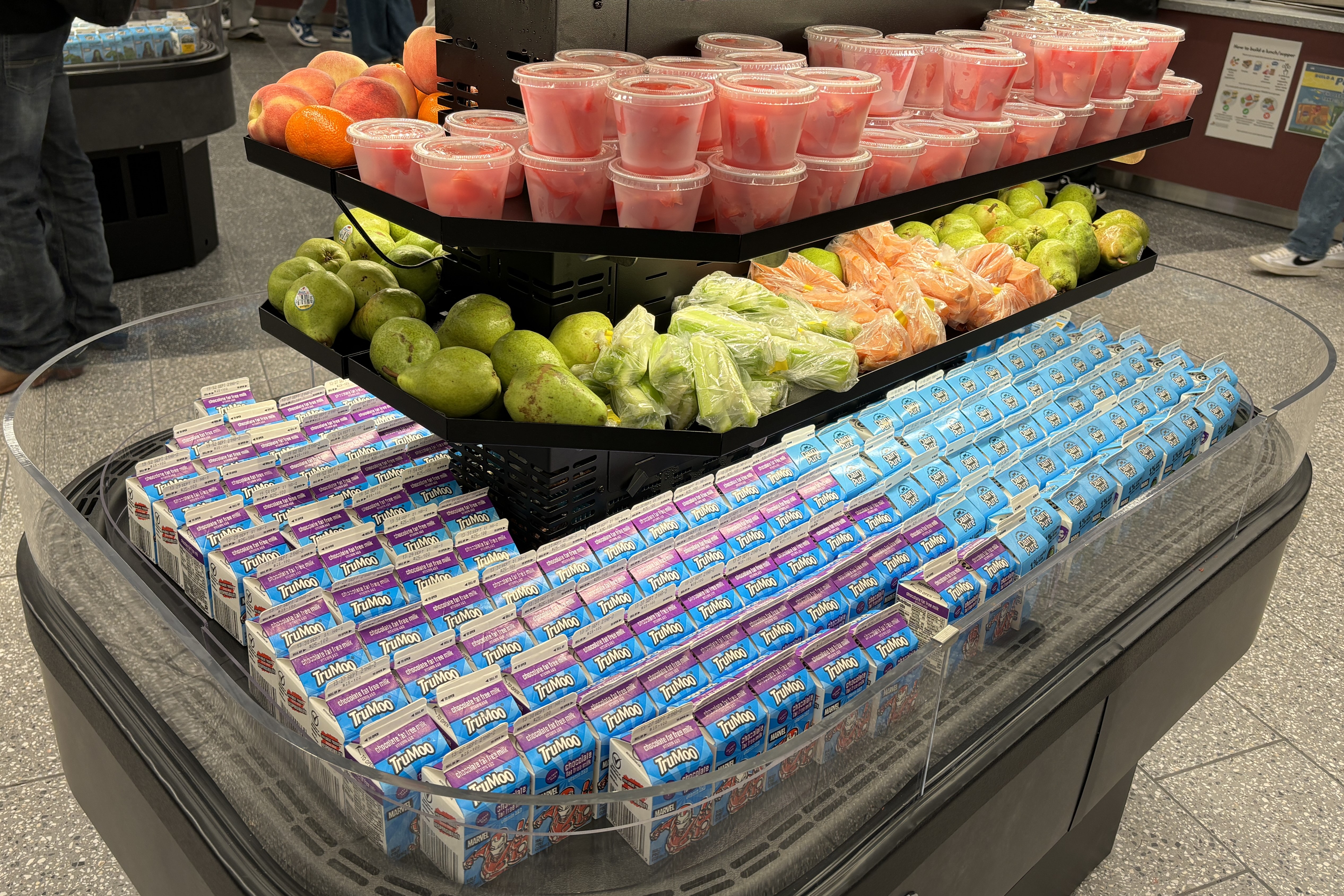  A colorful display of fresh fruit and milk cartons in a school cafeteria.