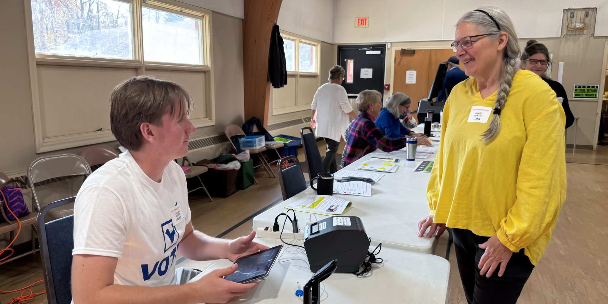 A high school student volunteers at the voting polls during election season.