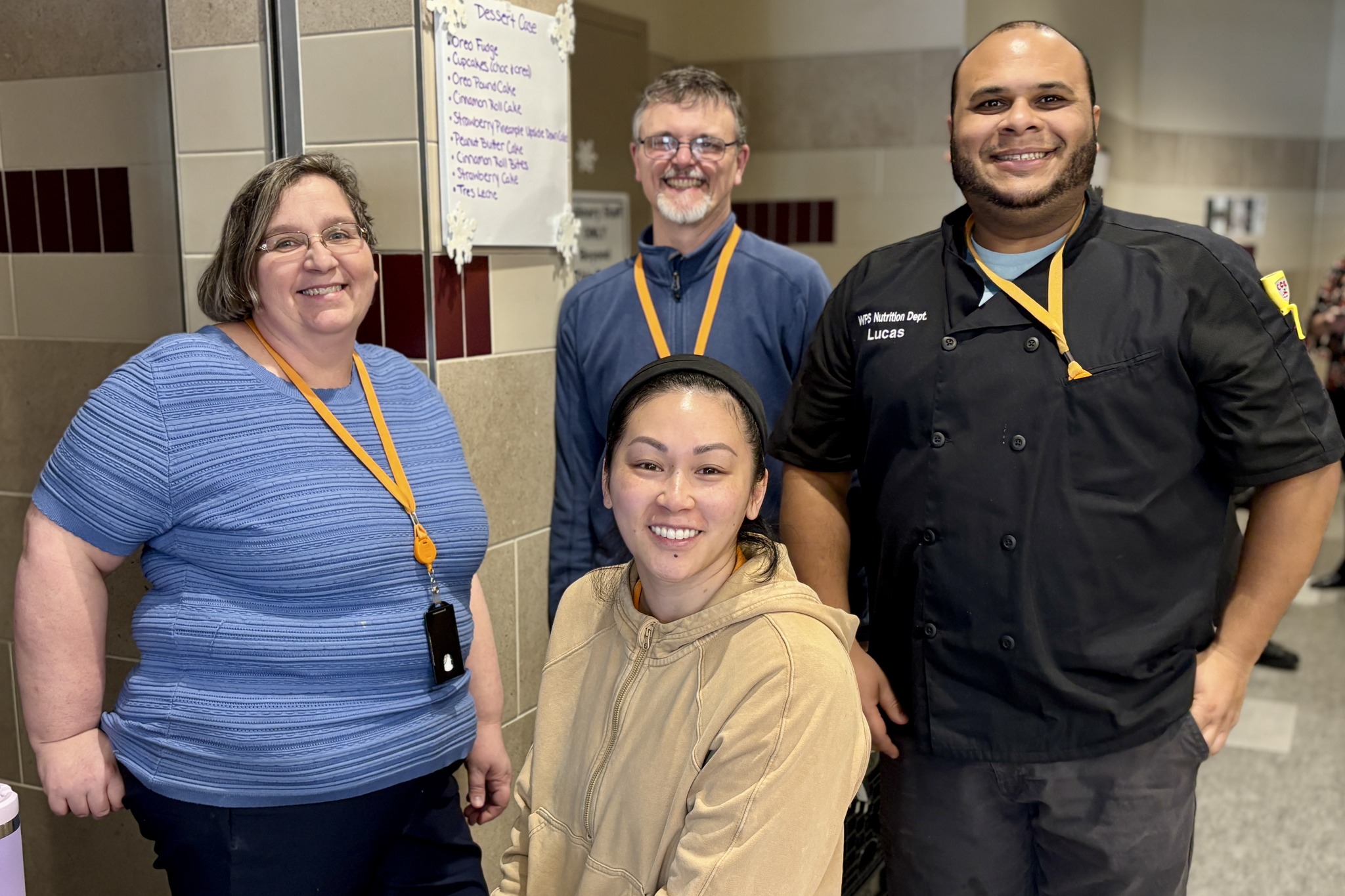 Four staff members smile for a photo