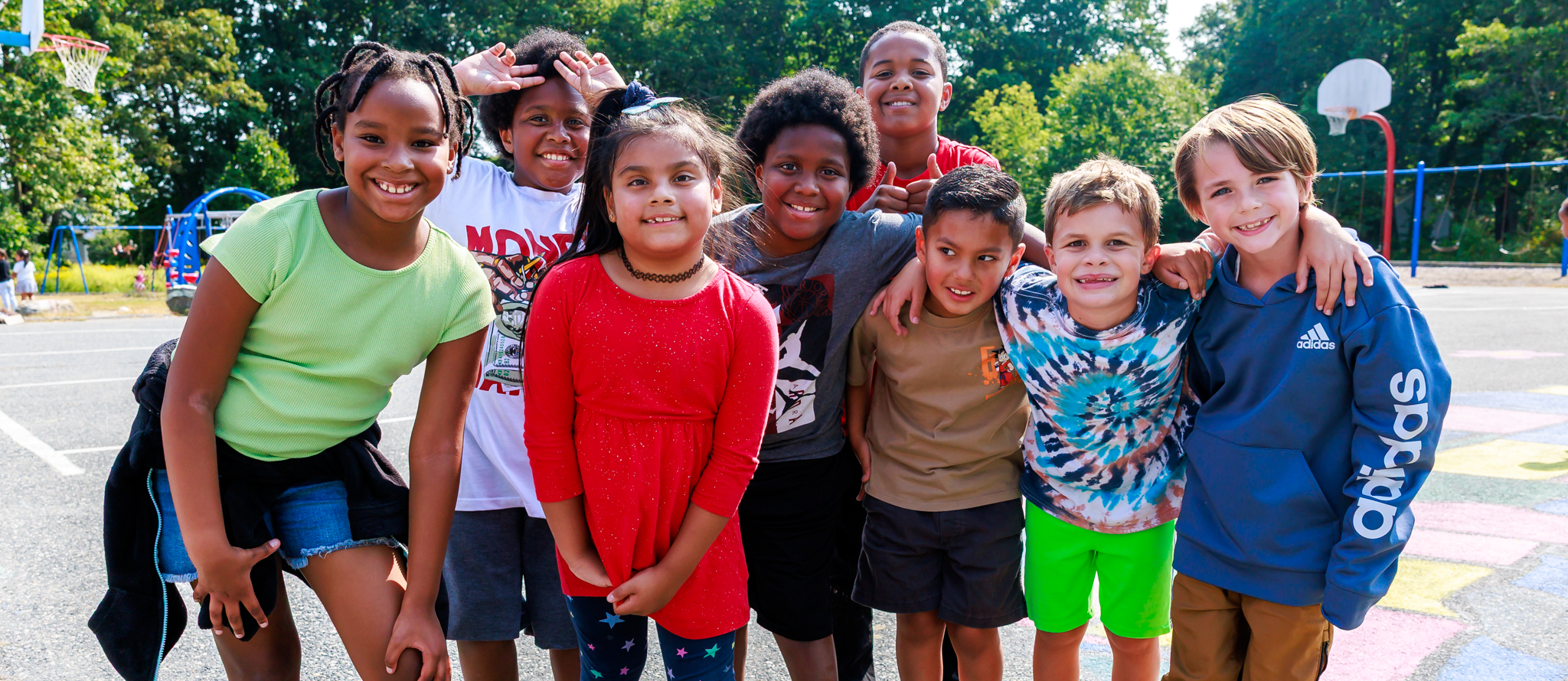 A group of students smile together for a photo.