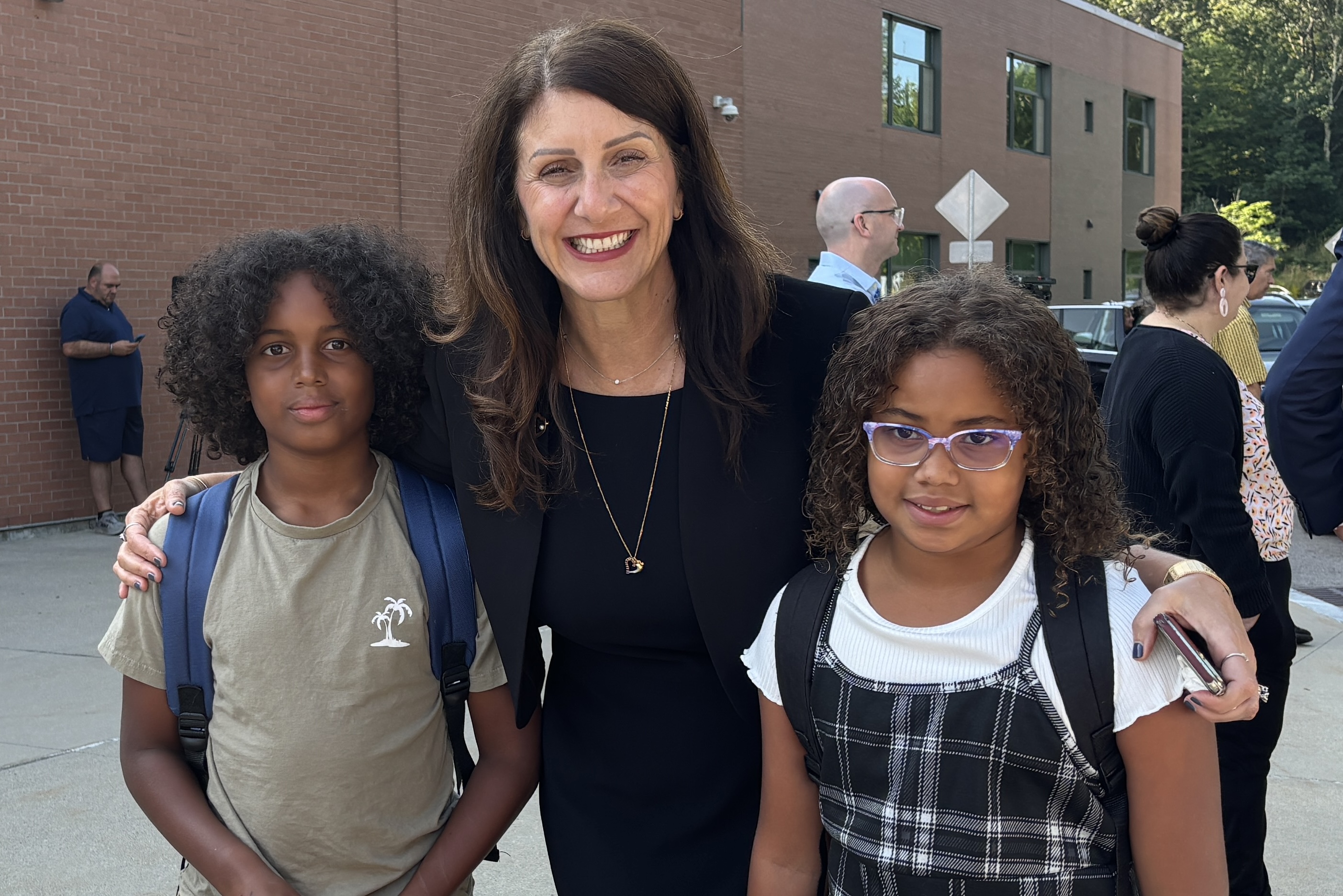 Superintendent Monárrez smiling with a boy and a girl of elementary school age