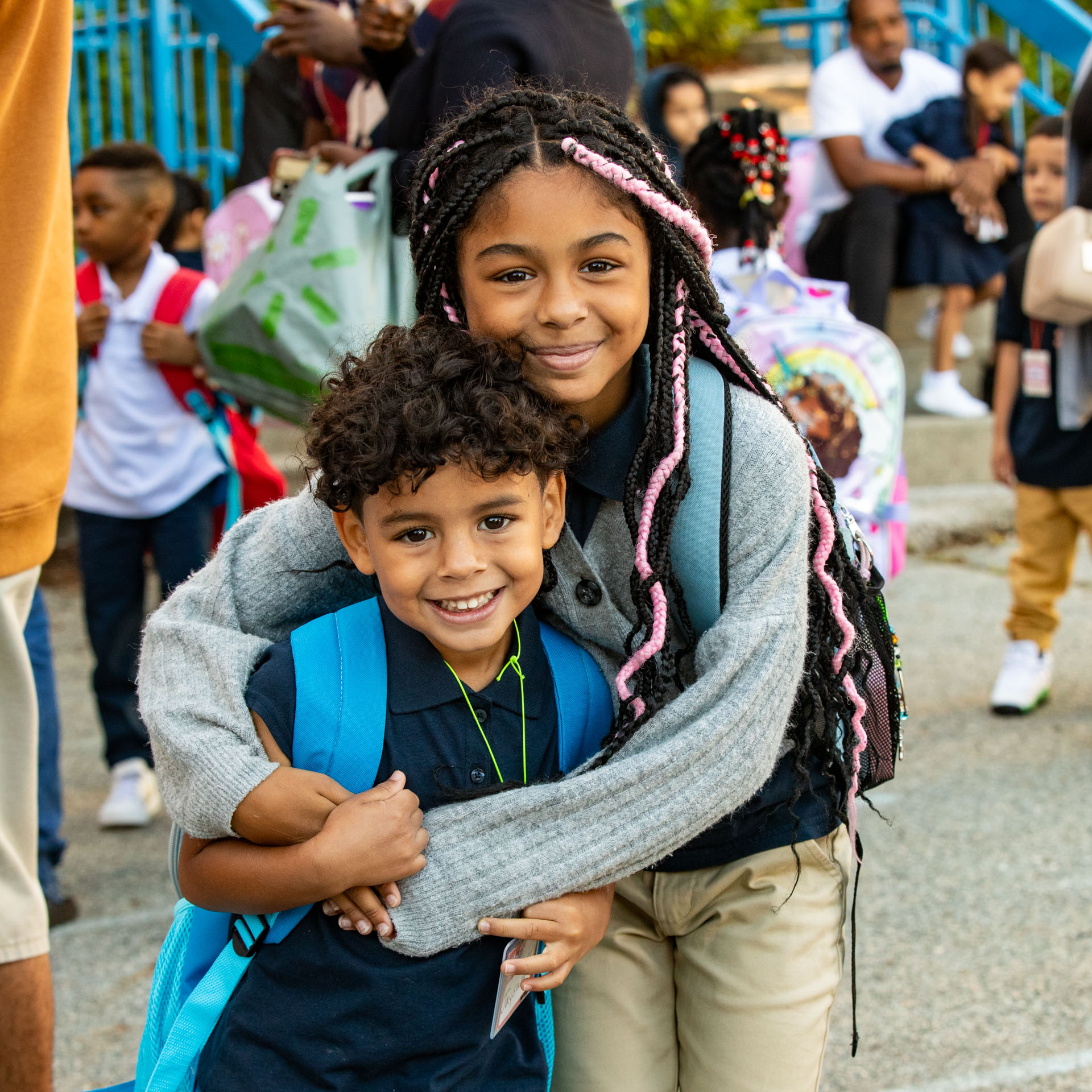 A young brother and sister hugging