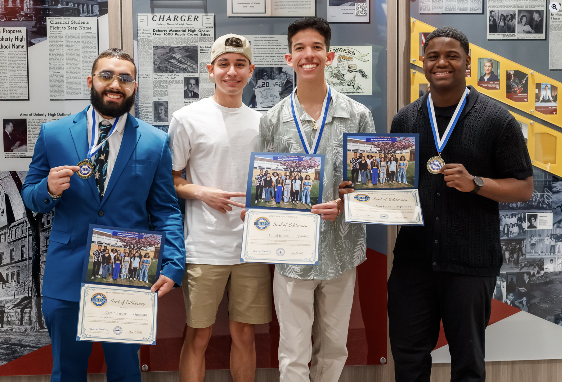 Four young men holding certificates