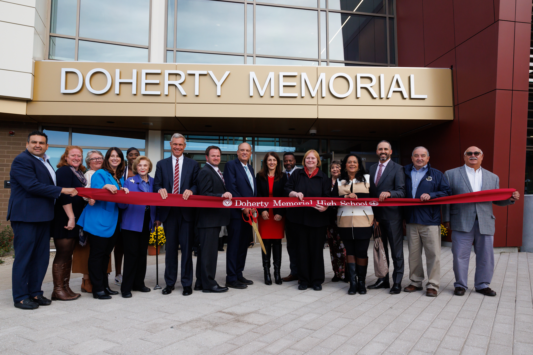Officials holding a ribbon during an opening ceremony at the new Doherty High School