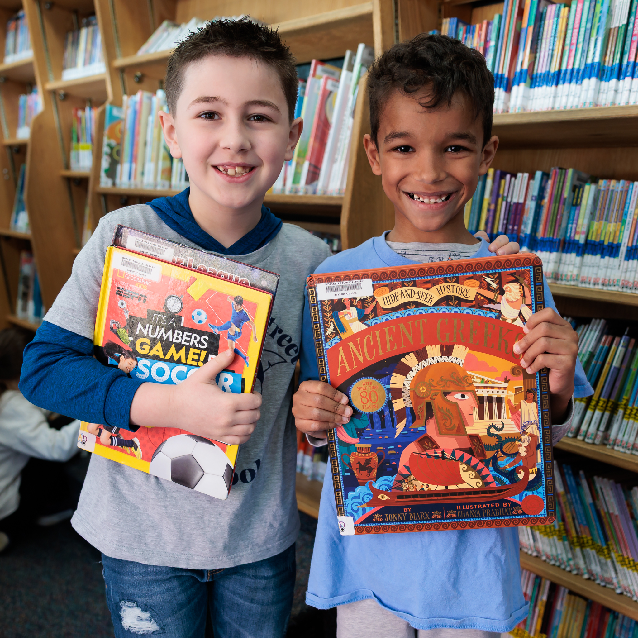 Two students from Midland Street hold up books.