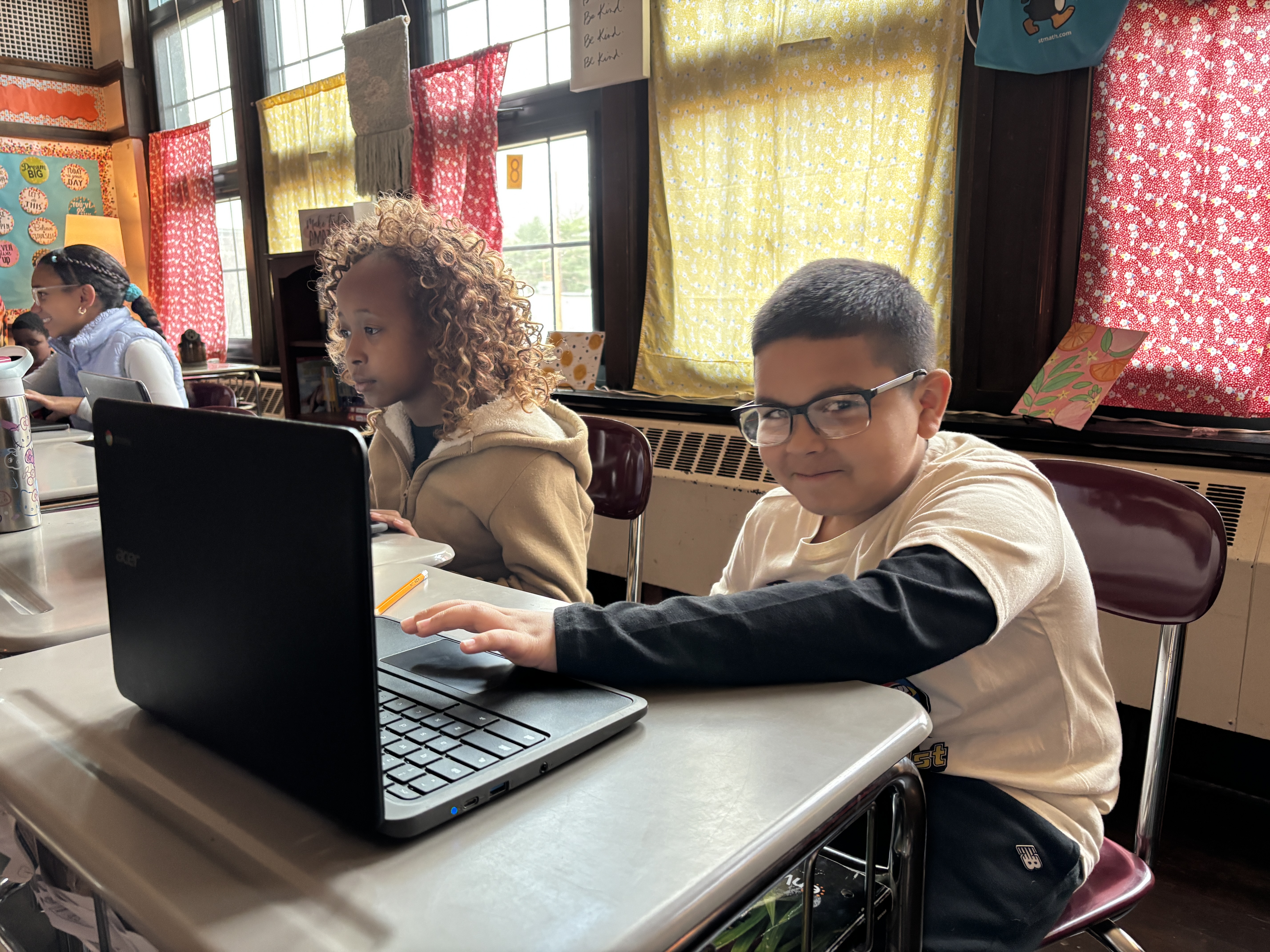 This is a photo of an elementary student using a Chromebook during class
