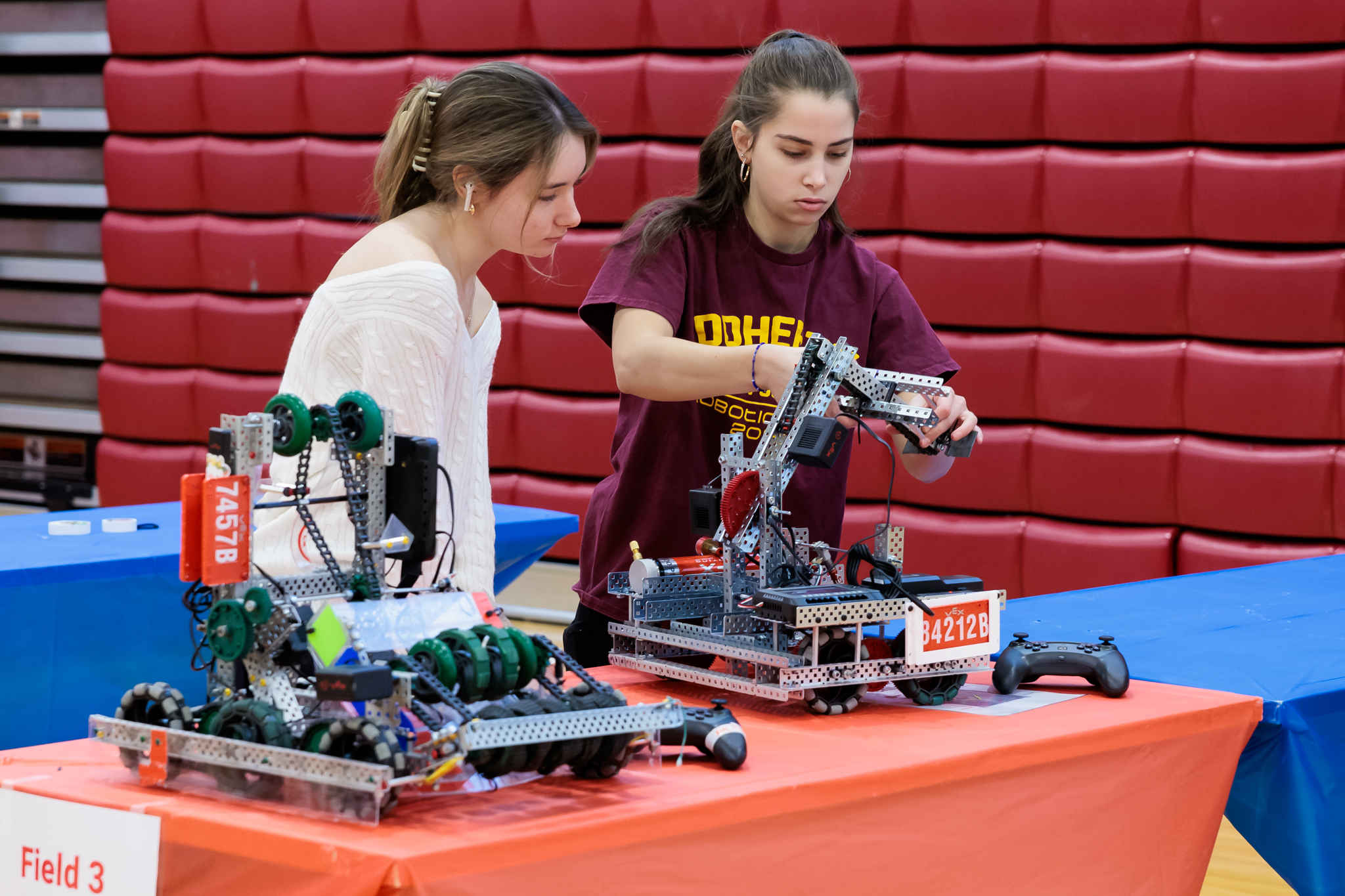 This is a photo of two students working on a VEX robot