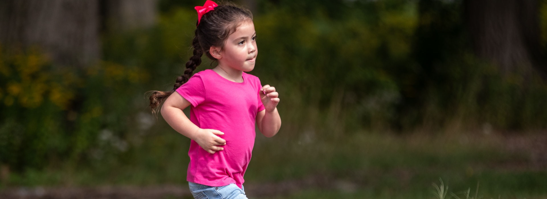 A girl runs outside at recess