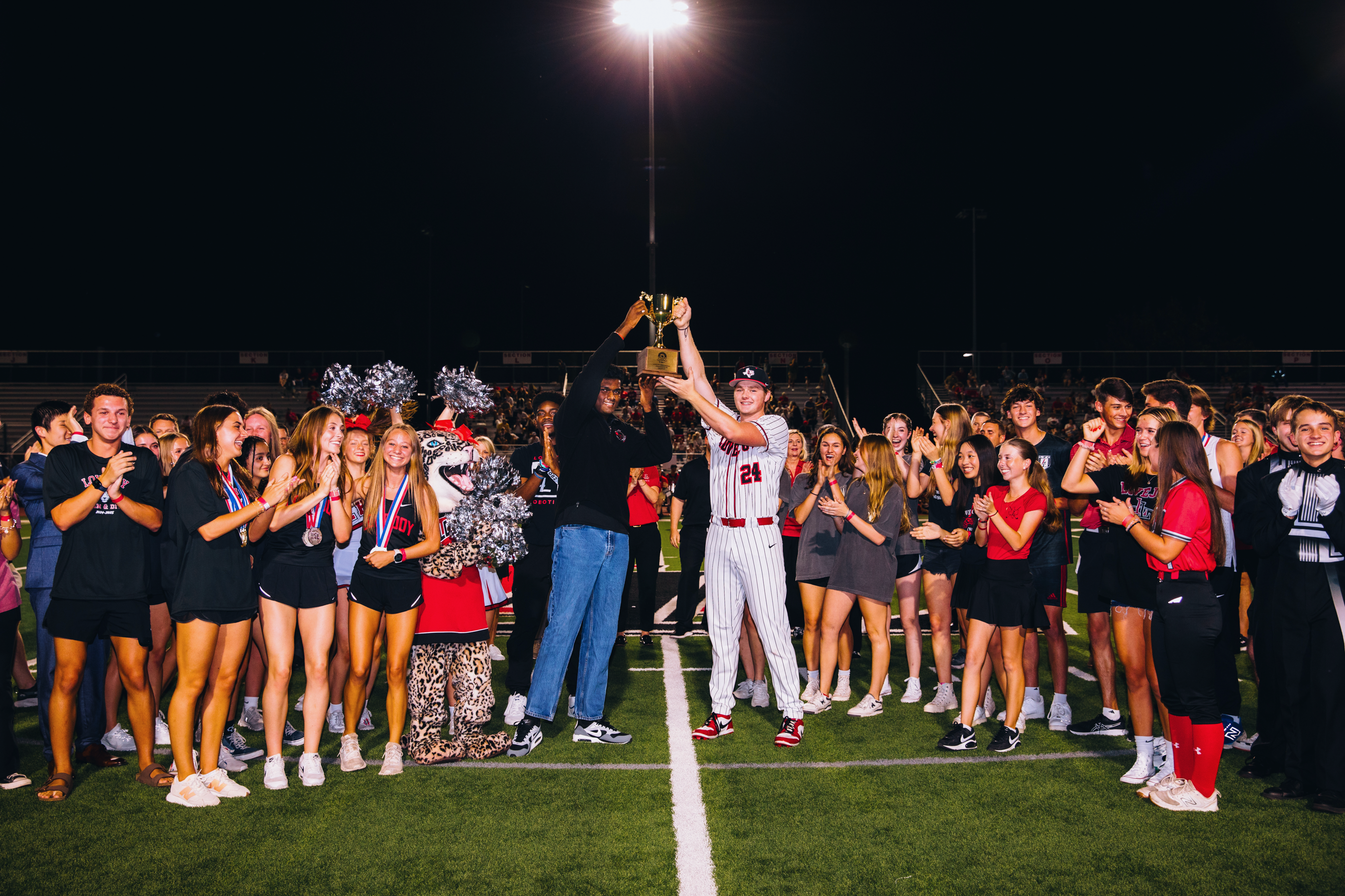 Students celebrating Lone Star Cup championship holding trophy