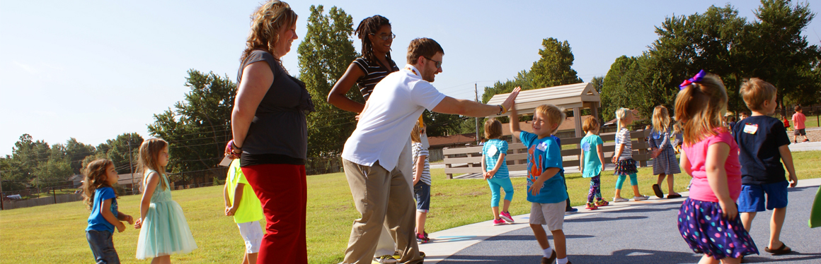 Picture of teacher greeting students.