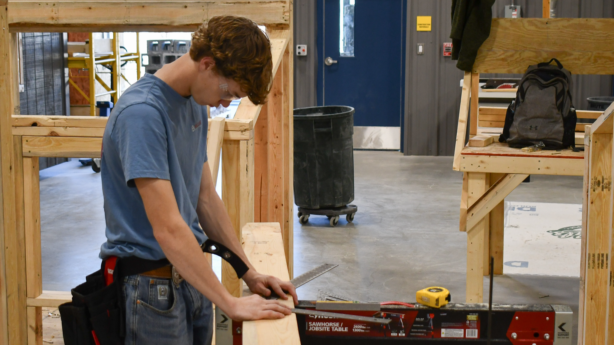 Student measuring in construction lab
