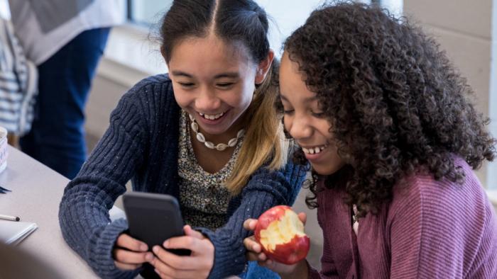 Two students looking at phone