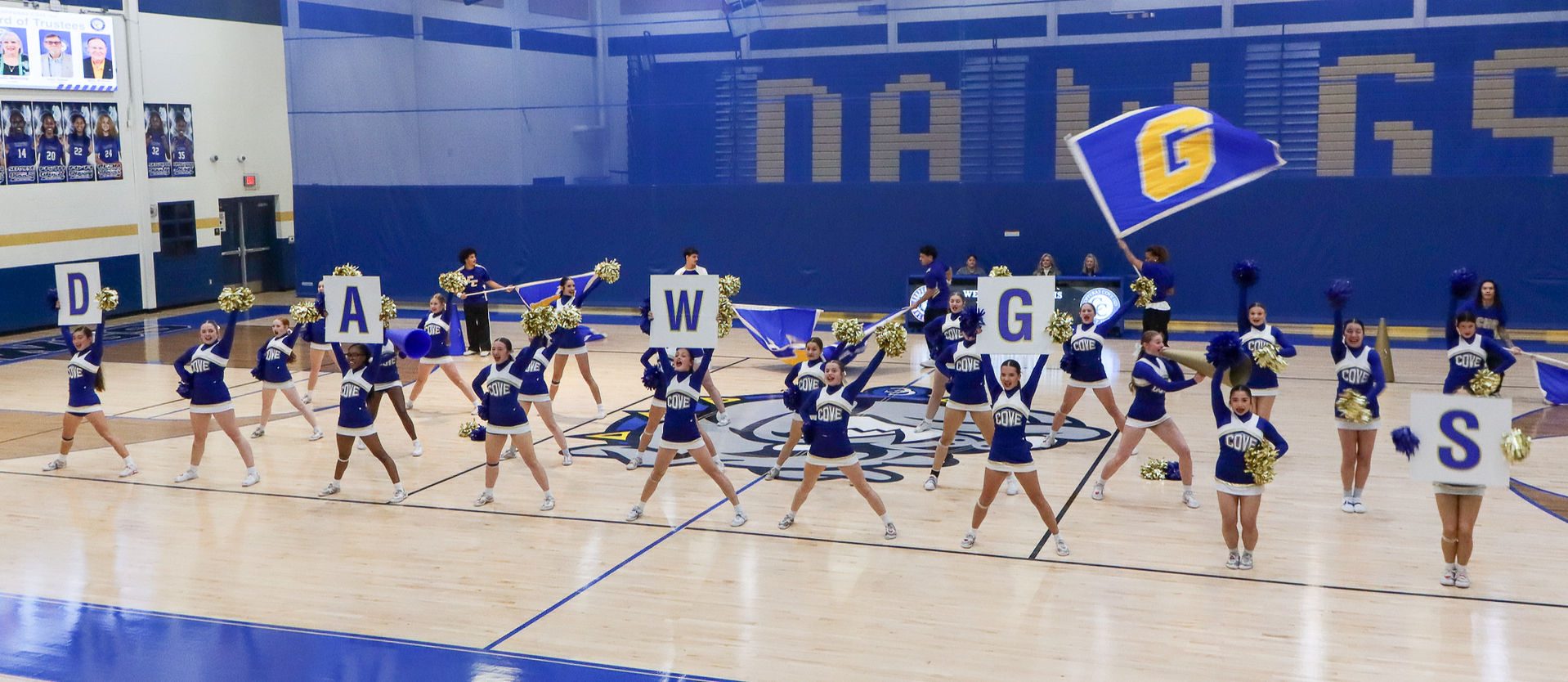 Cheerleaders performing a routine in a gym