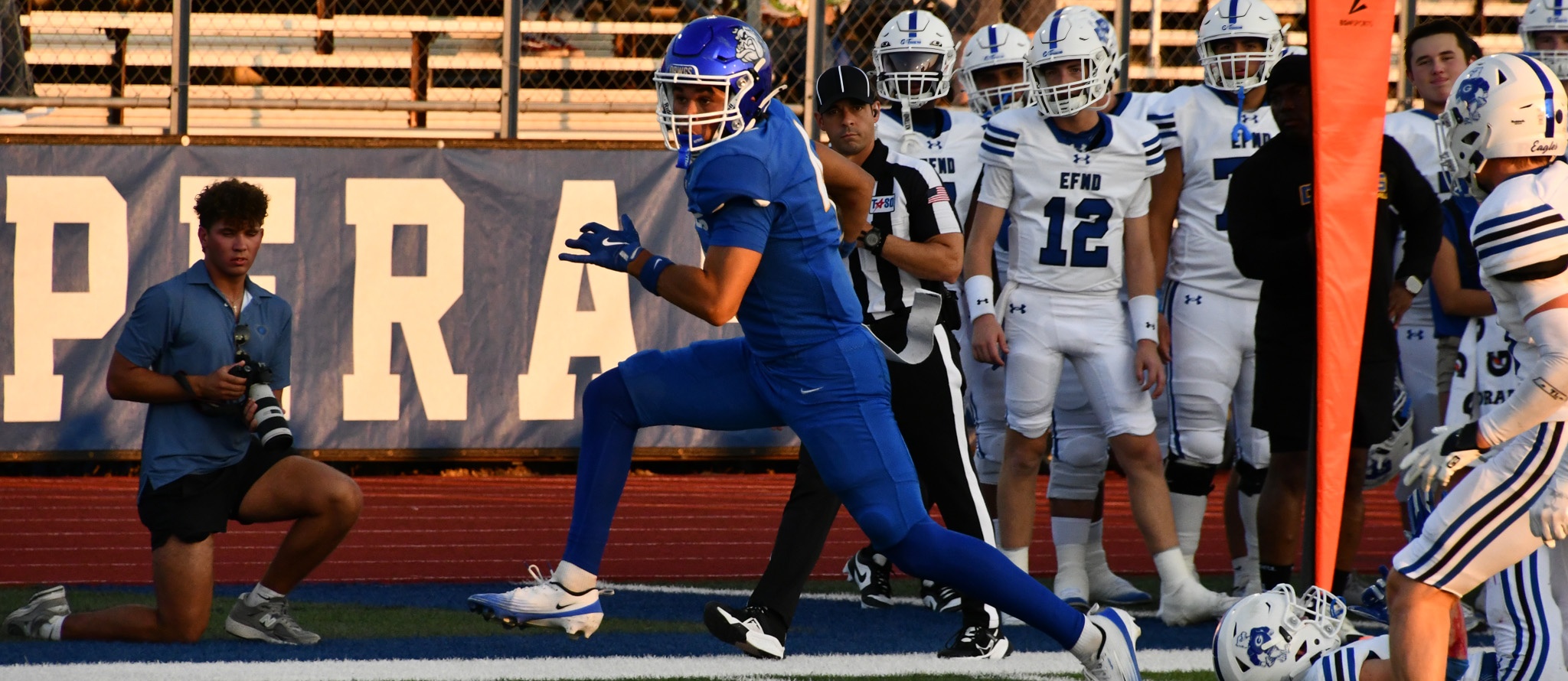CCHS football player carries the ball in bulldog stadium